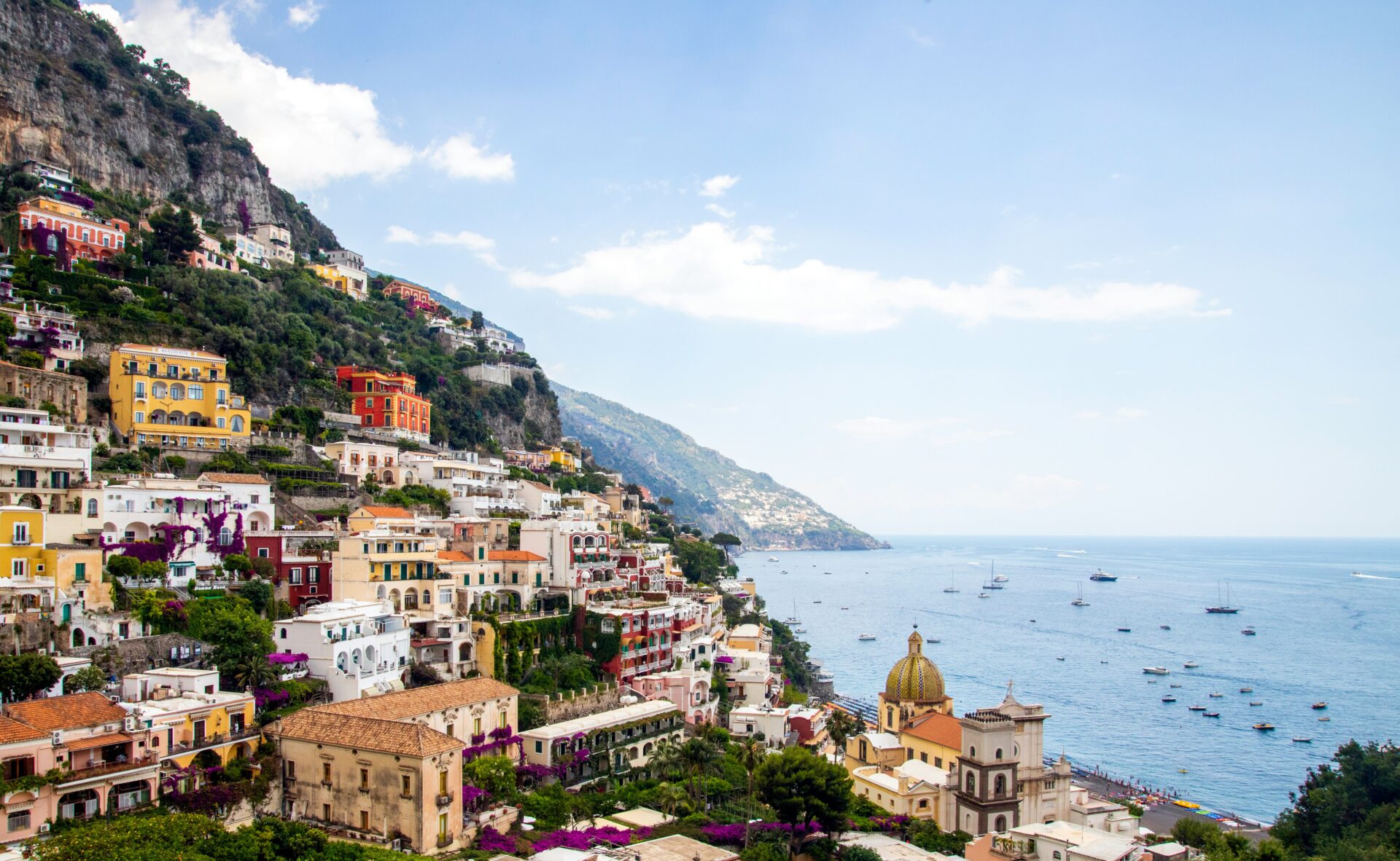 Colorful hillside buildings overlooking the sea along Viale Pasitea in Positano, Italy.