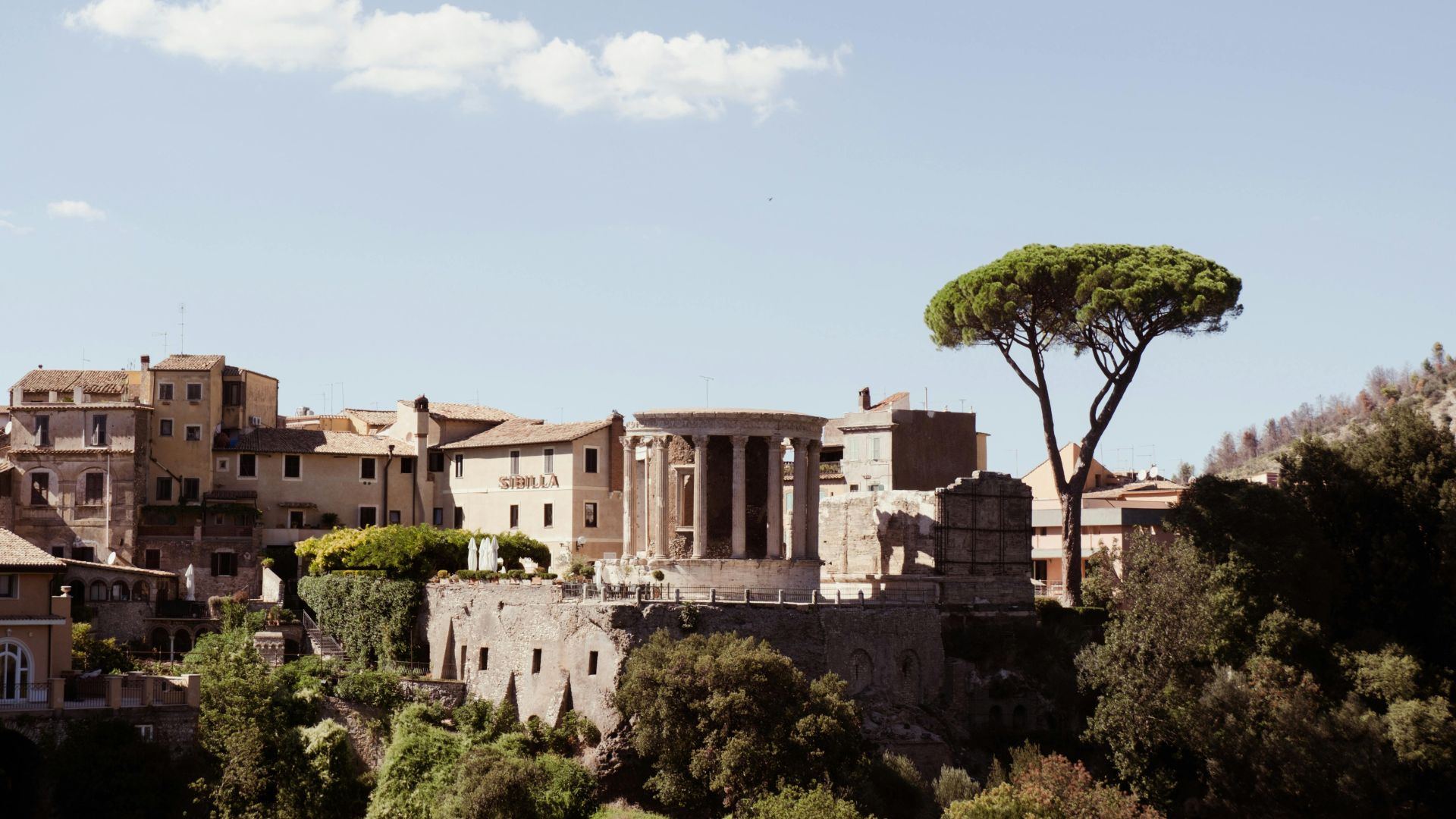 The image shows the Temple of Vesta in Tivoli, located within the Villa Gregoriana park. Villa Gregoriana is a park in Tivoli, Italy