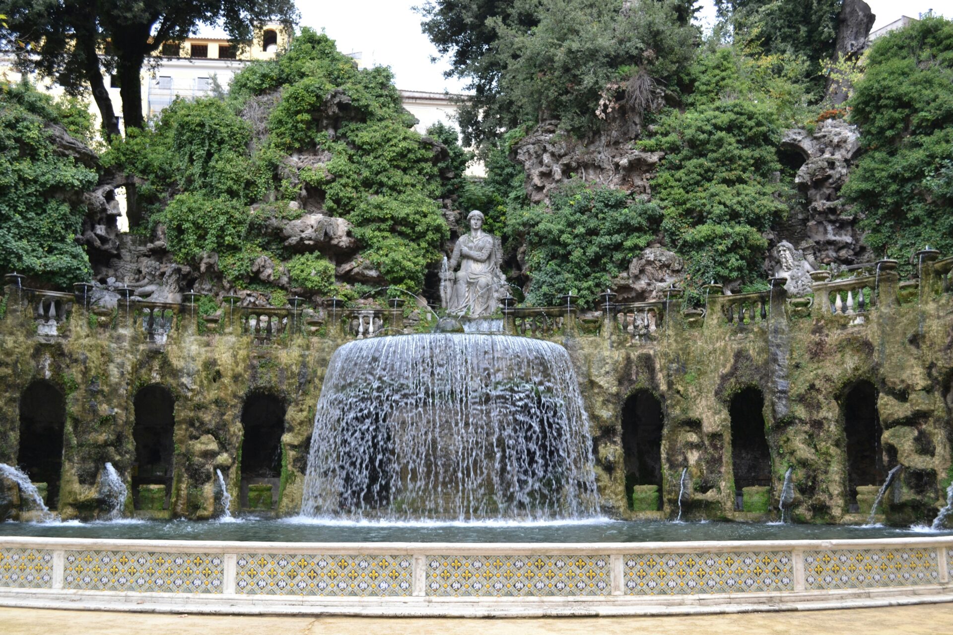 Villa d’Este in Tivoli, Italy, with its Renaissance architecture and stunning terraced gardens featuring elaborate fountains and lush greenery.