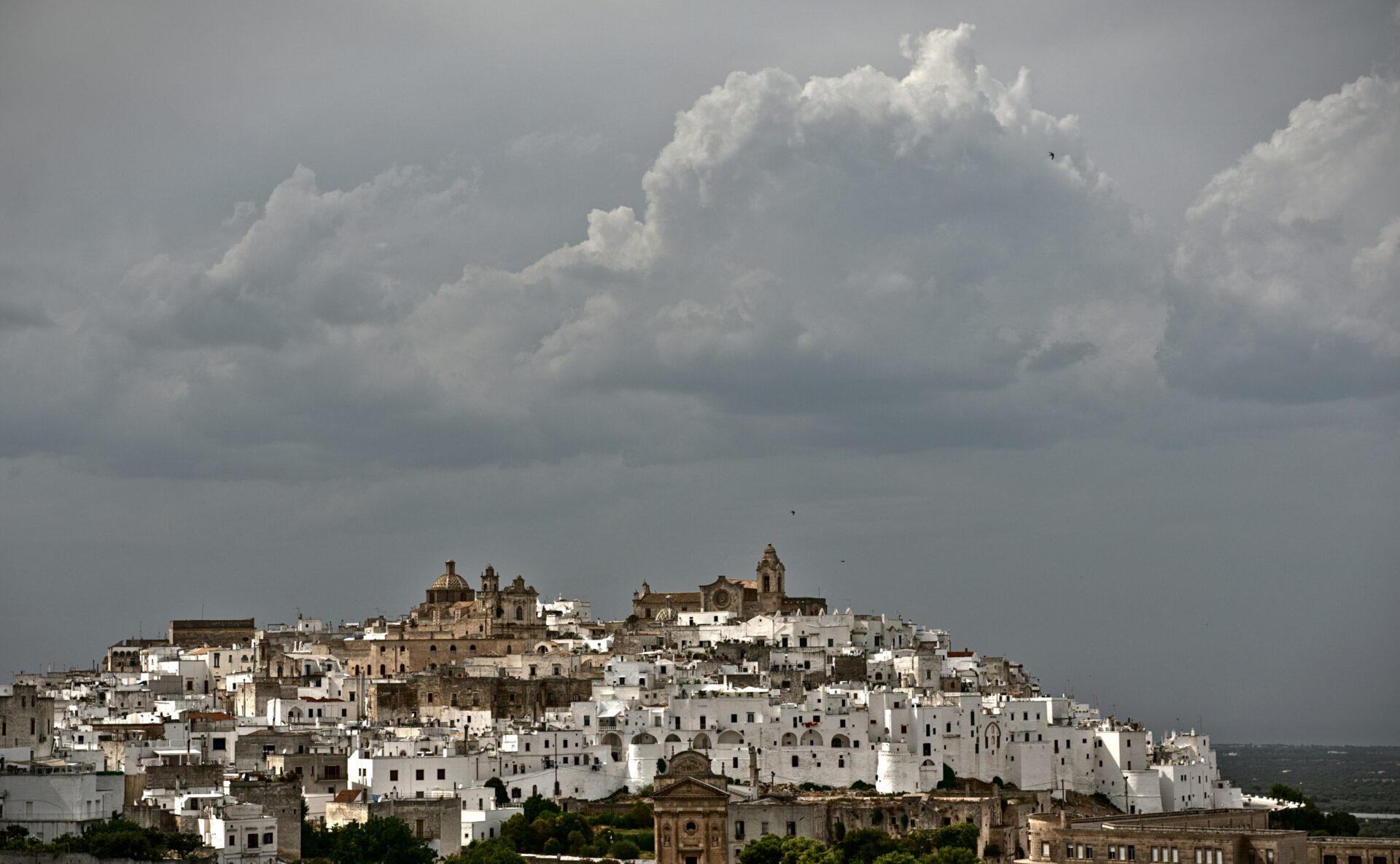 Aerial view of Ostuni, Italy, showcasing the whitewashed buildings of the historic hilltop town