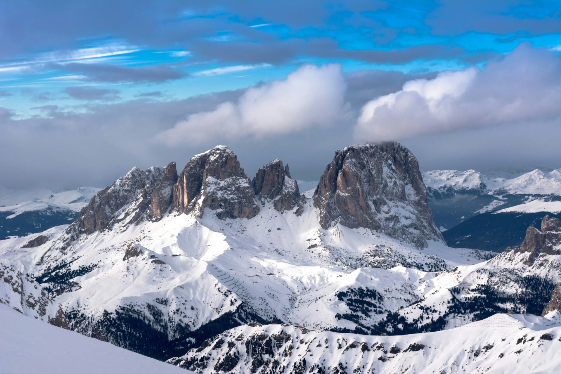 Snow-covered mountain range in Sassolungo