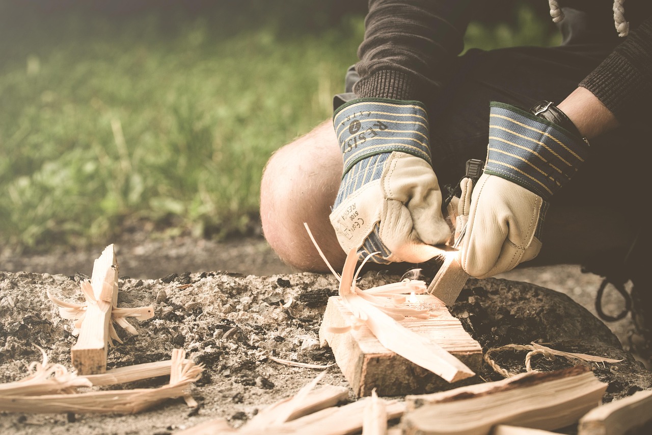 Person making fire with wood