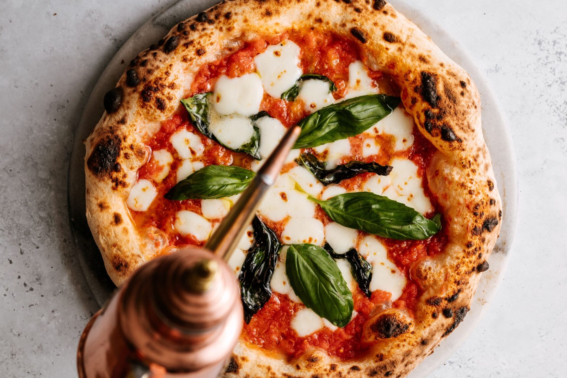pizza with San Marzano tomatoes, mozzarella, basil, and olive oil