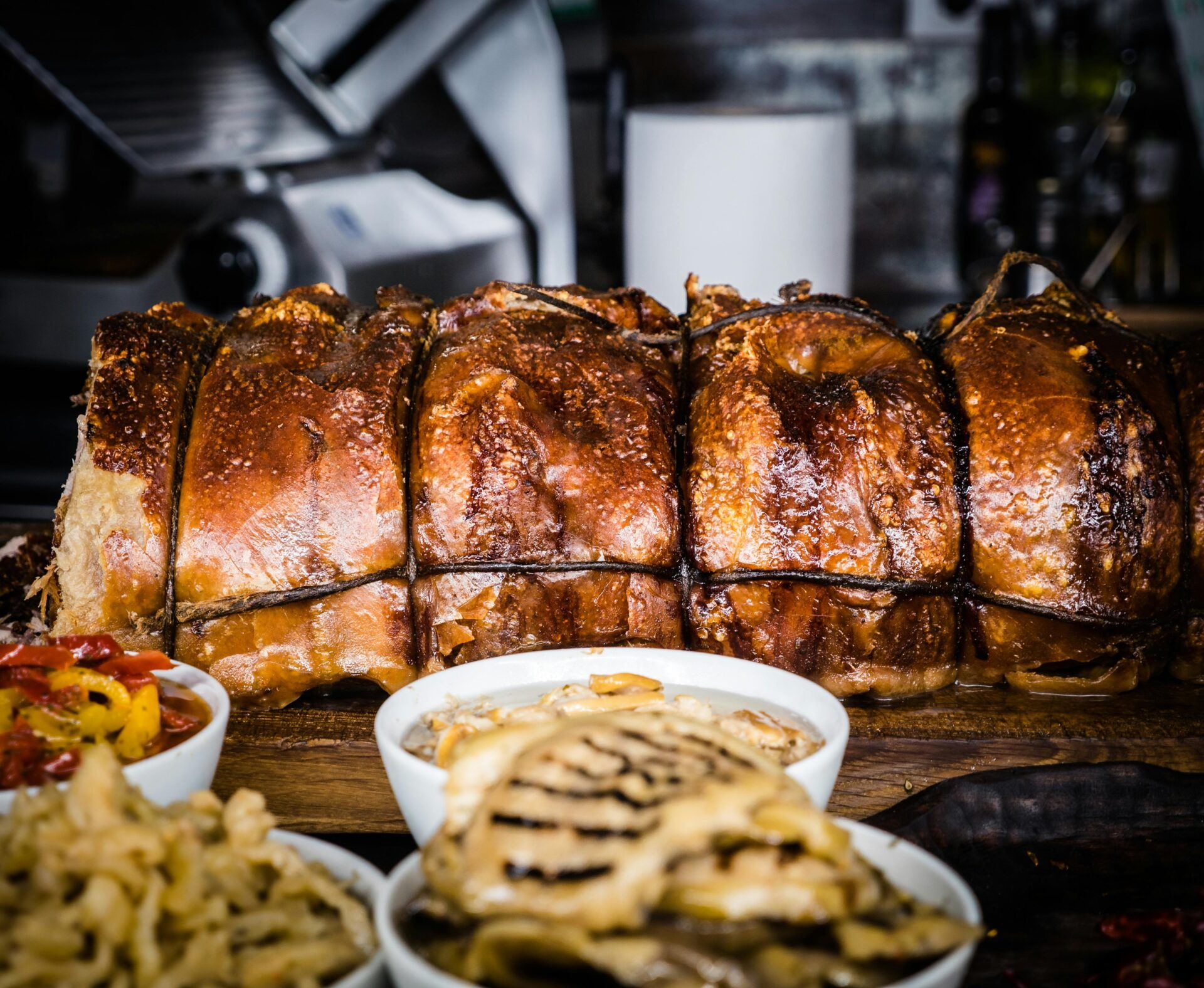 Traditional Porchetta roast – herb-stuffed pork with crispy skin, served in Orvieto, Umbria countryside.