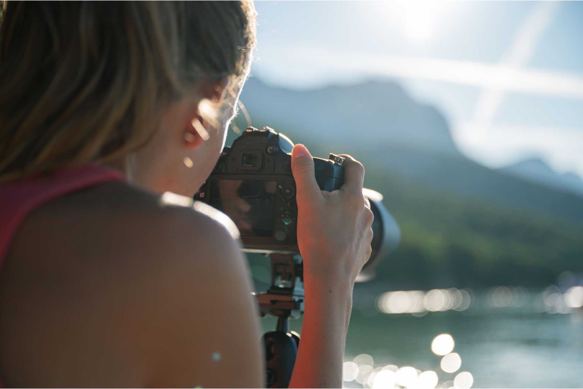 woman taking pictures on the beach