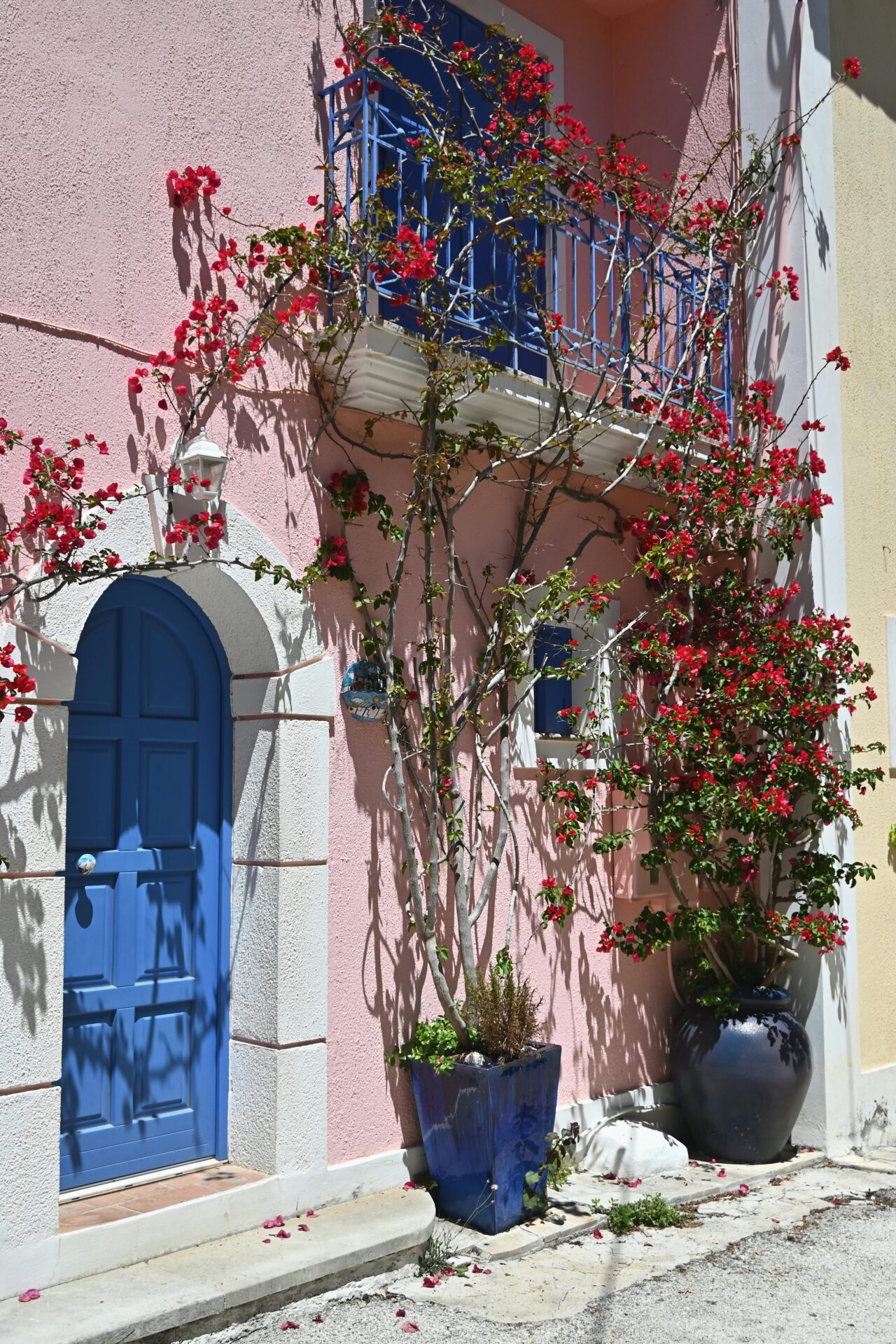 A pastel pink-colored house in Athens with Bougainvillea