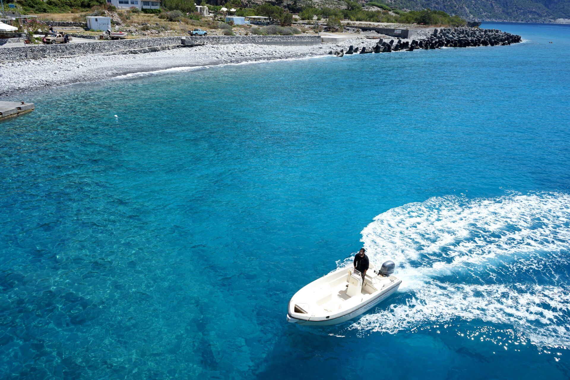 Boat gliding along the shoreline of Agia Roumeli Beach