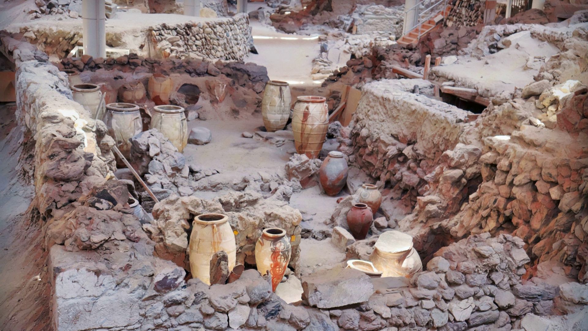 Archaeological site of Akrotiri, Santorini, Greece, showing ancient ruins and pots.