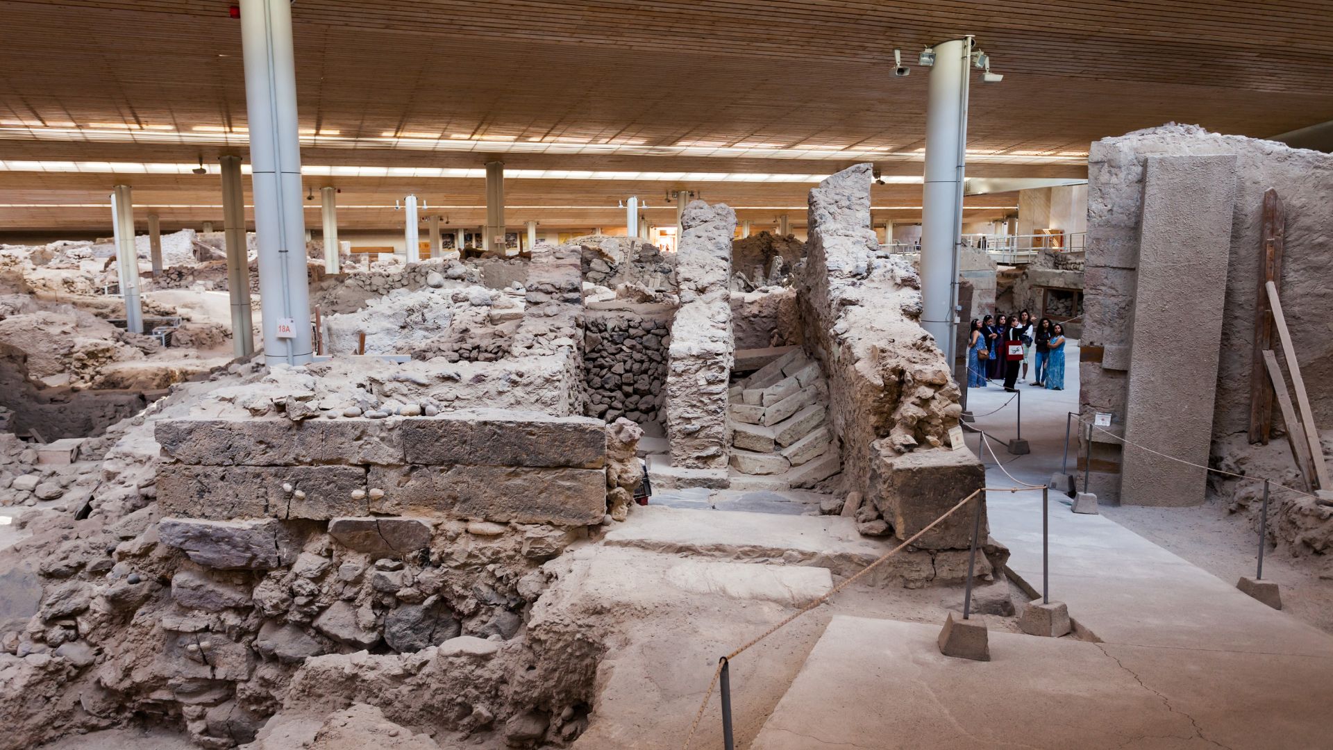Archaeological site of Akrotiri, Santorini, Greece, showing ancient ruins under a protective roof.