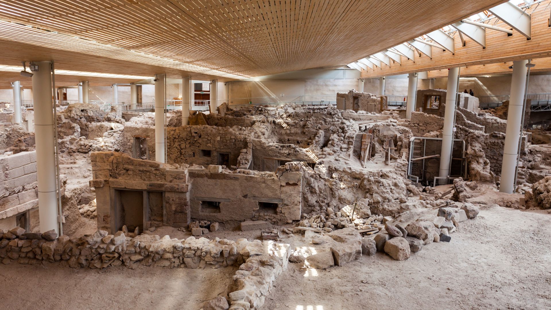 Archaeological site of Akrotiri, Santorini, Greece, showing ancient ruins under a protective roof.