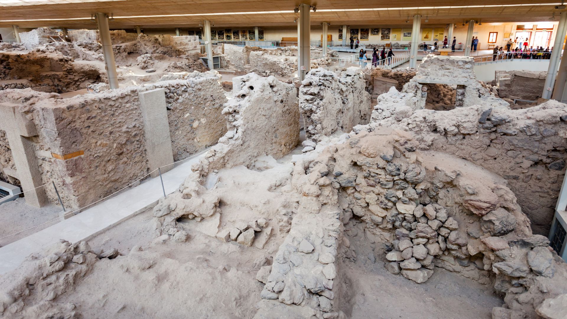 Archaeological site of Akrotiri, Santorini, Greece, showing ancient ruins under a protective roof.