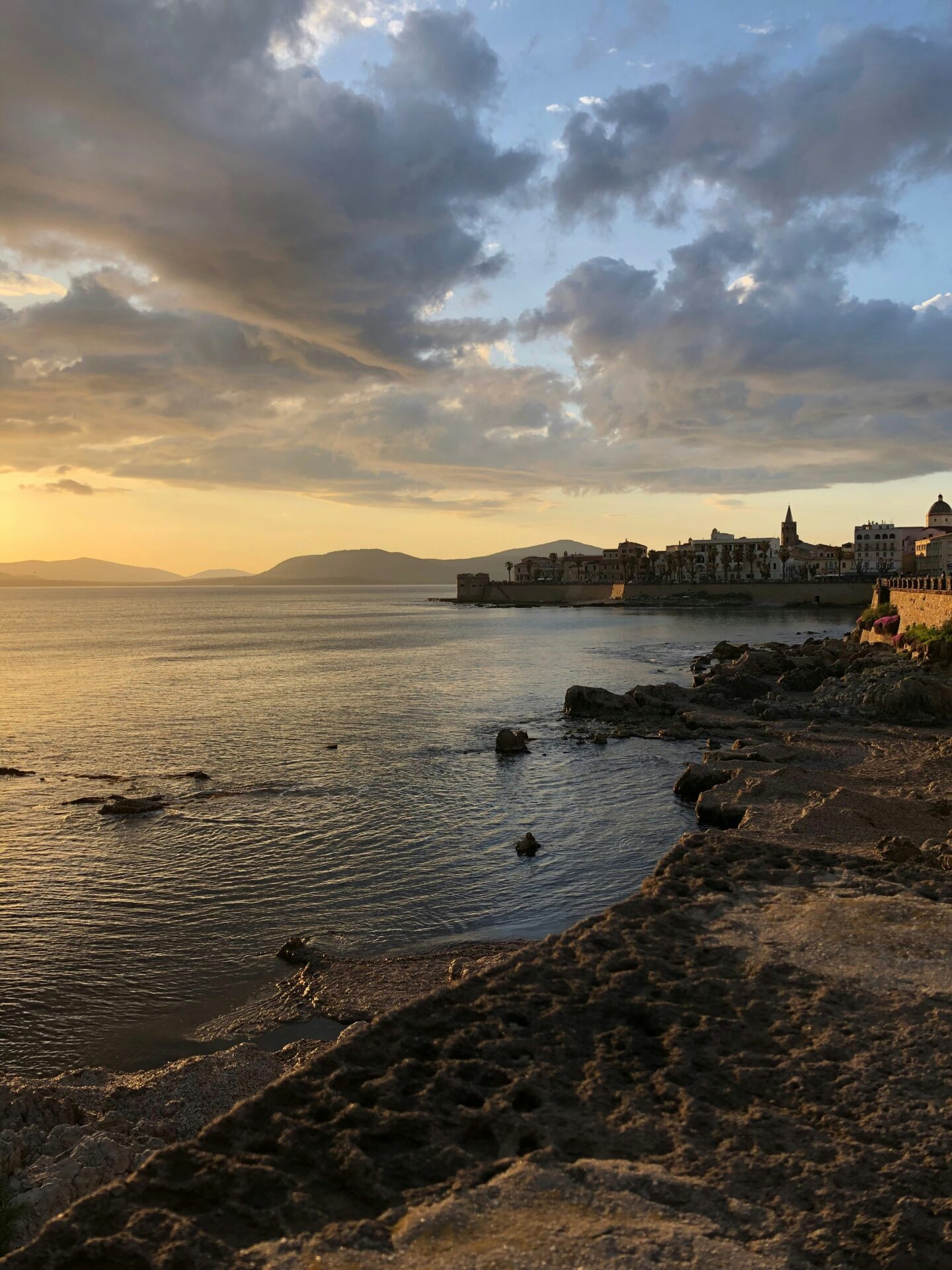 Sunset over Alghero’s rugged coastline