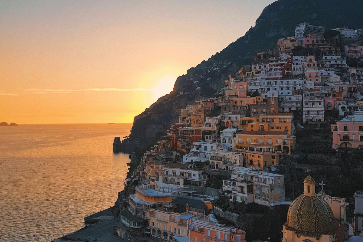 Scenic sunset of colorful houses and building stumbling the mountains inAmalfi Coast, Italy.