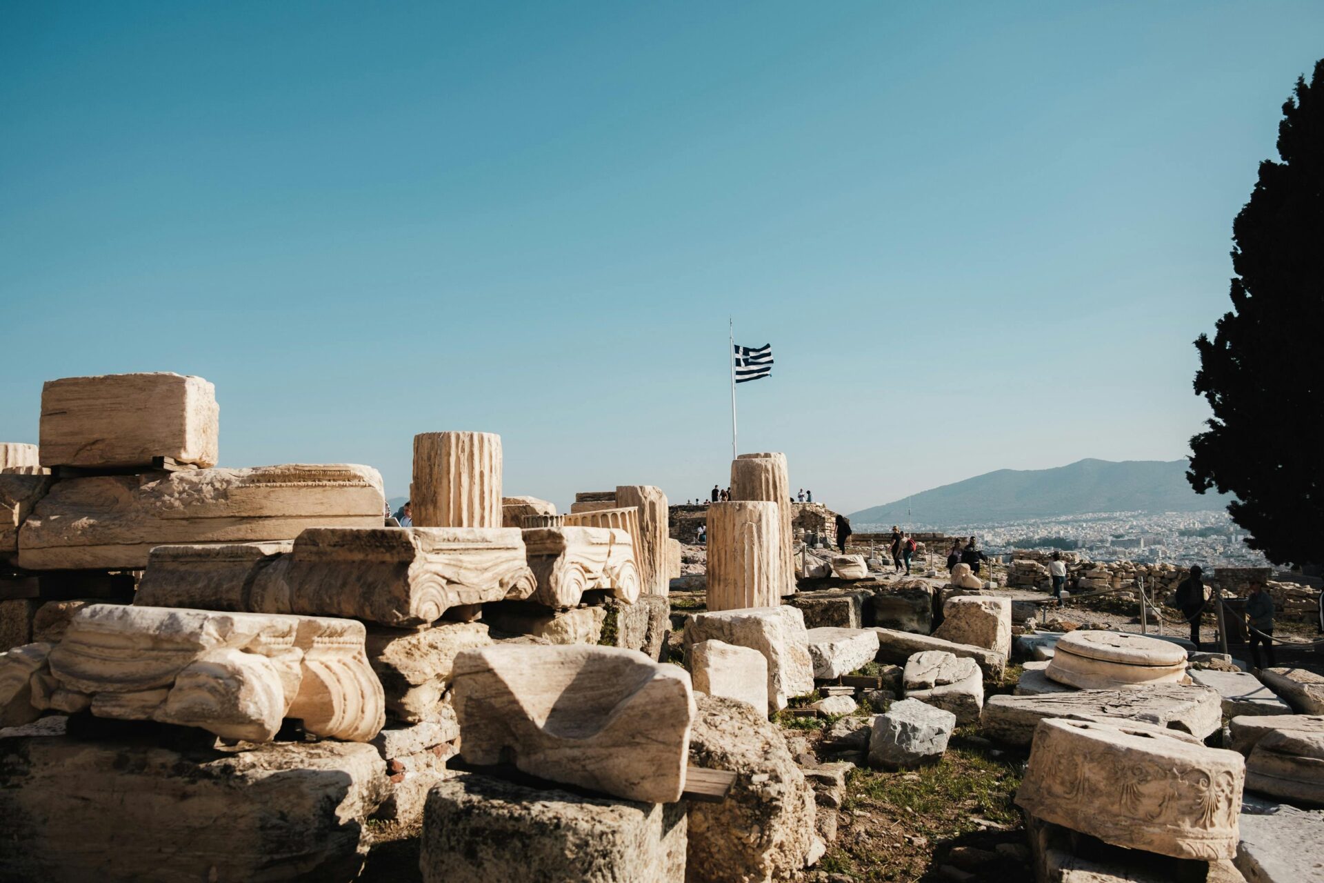 Ancient ruins with a Greece flag in Athens