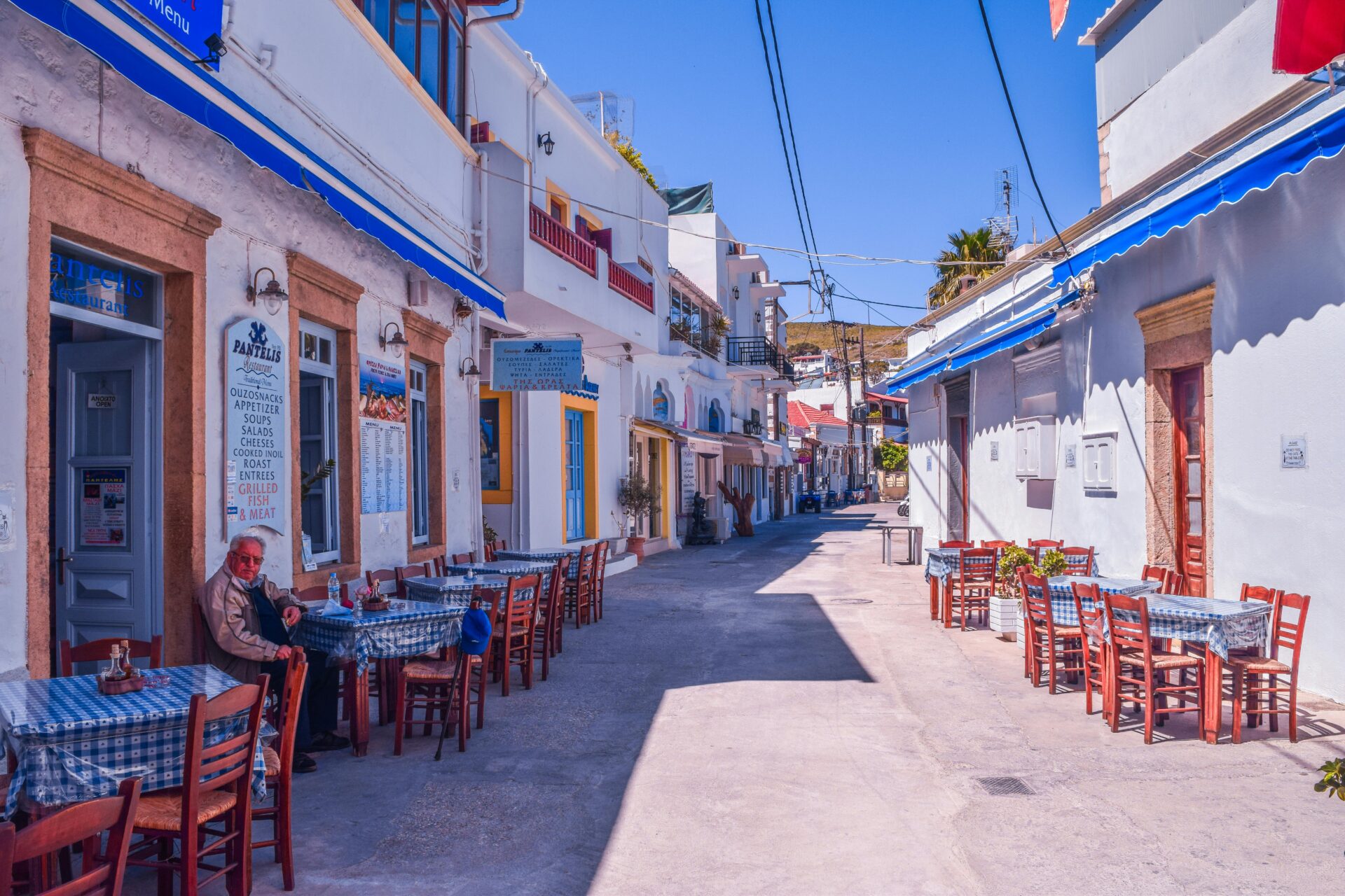 Cafe alley in Greece - brown, blue, and white accent