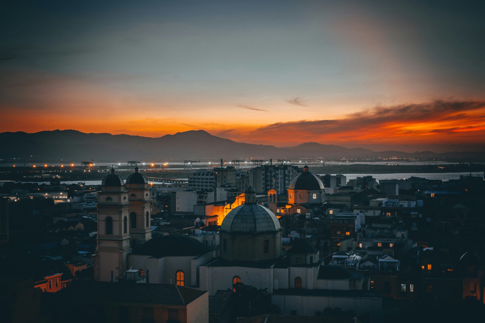 Night view of Cagliari, Sardinia, with warmly lit historic buildings