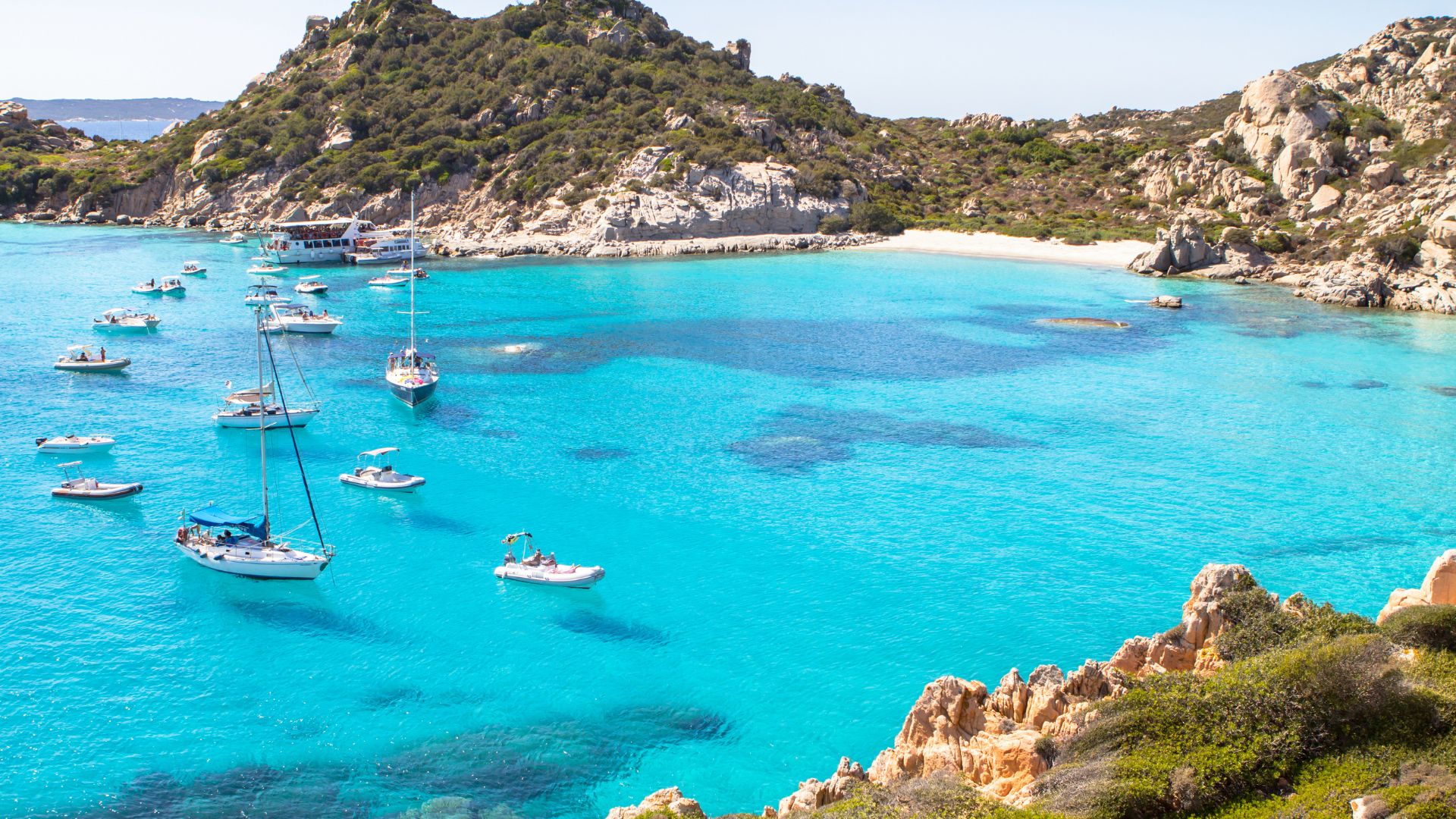 Boats in the turquoise water of Cala Corsara, Sardinia