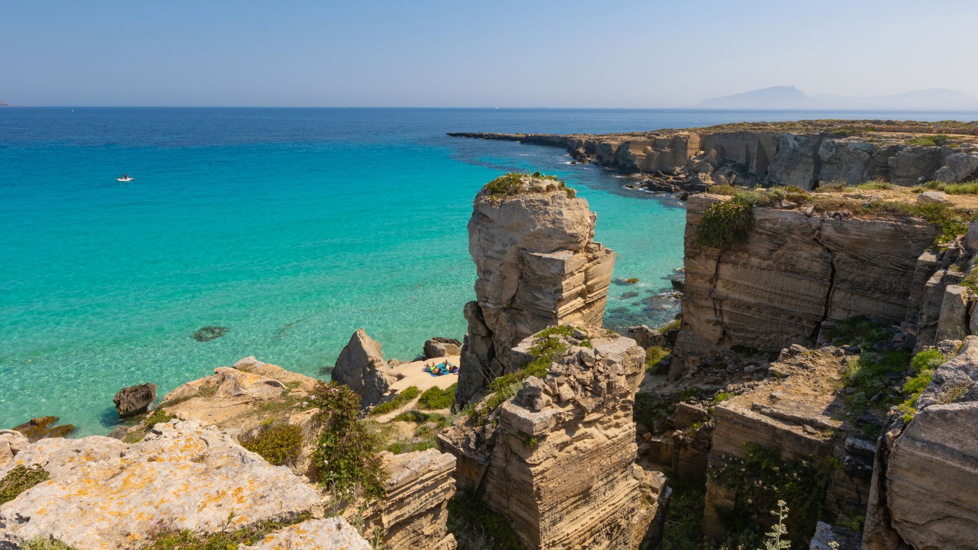 Cala Rossa beach with turquoise water and rocky cliffs on Favignana, Aegadian Islands