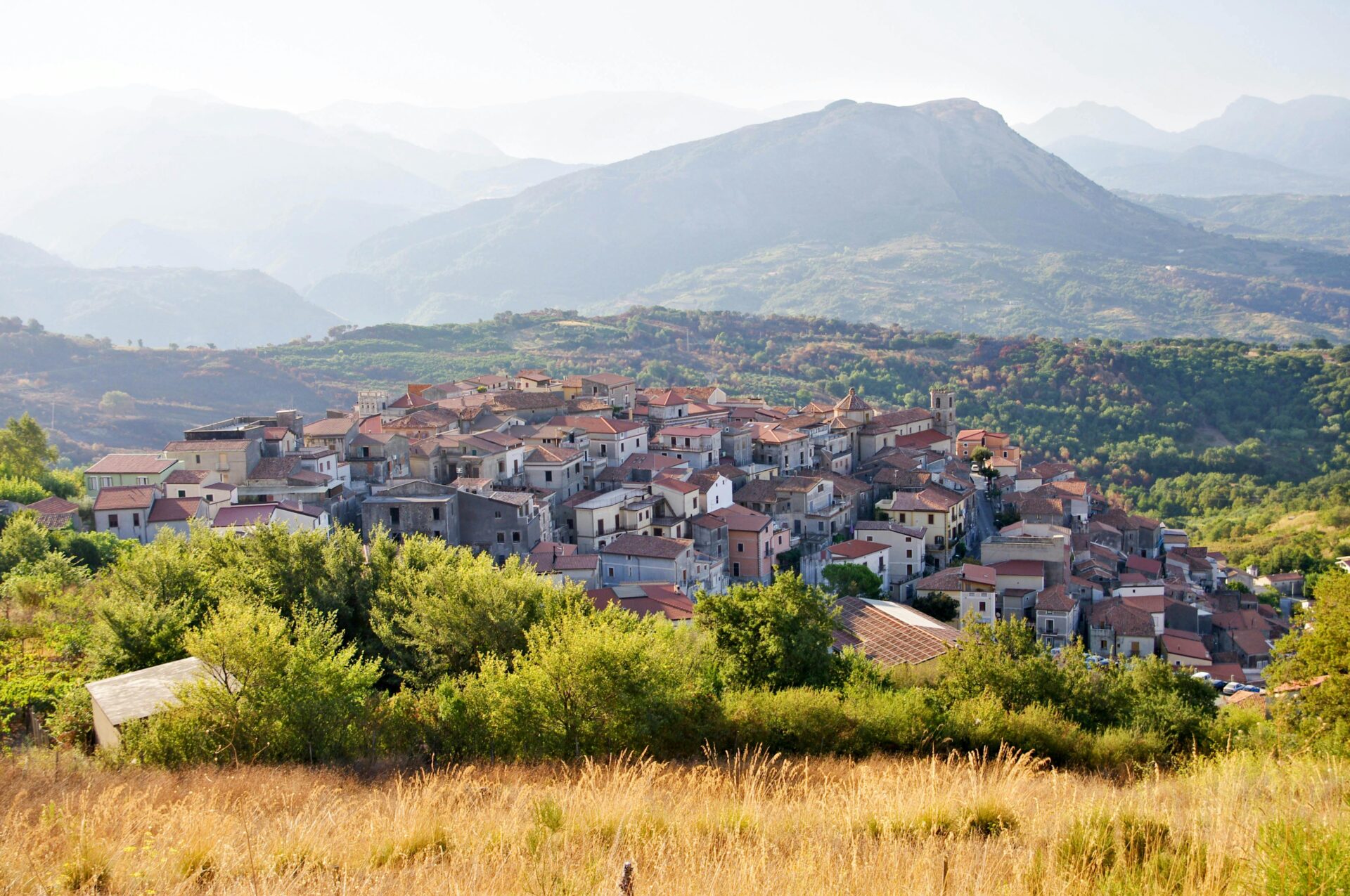 Charming Calabria village nestled at the foot of rugged mountain peaks