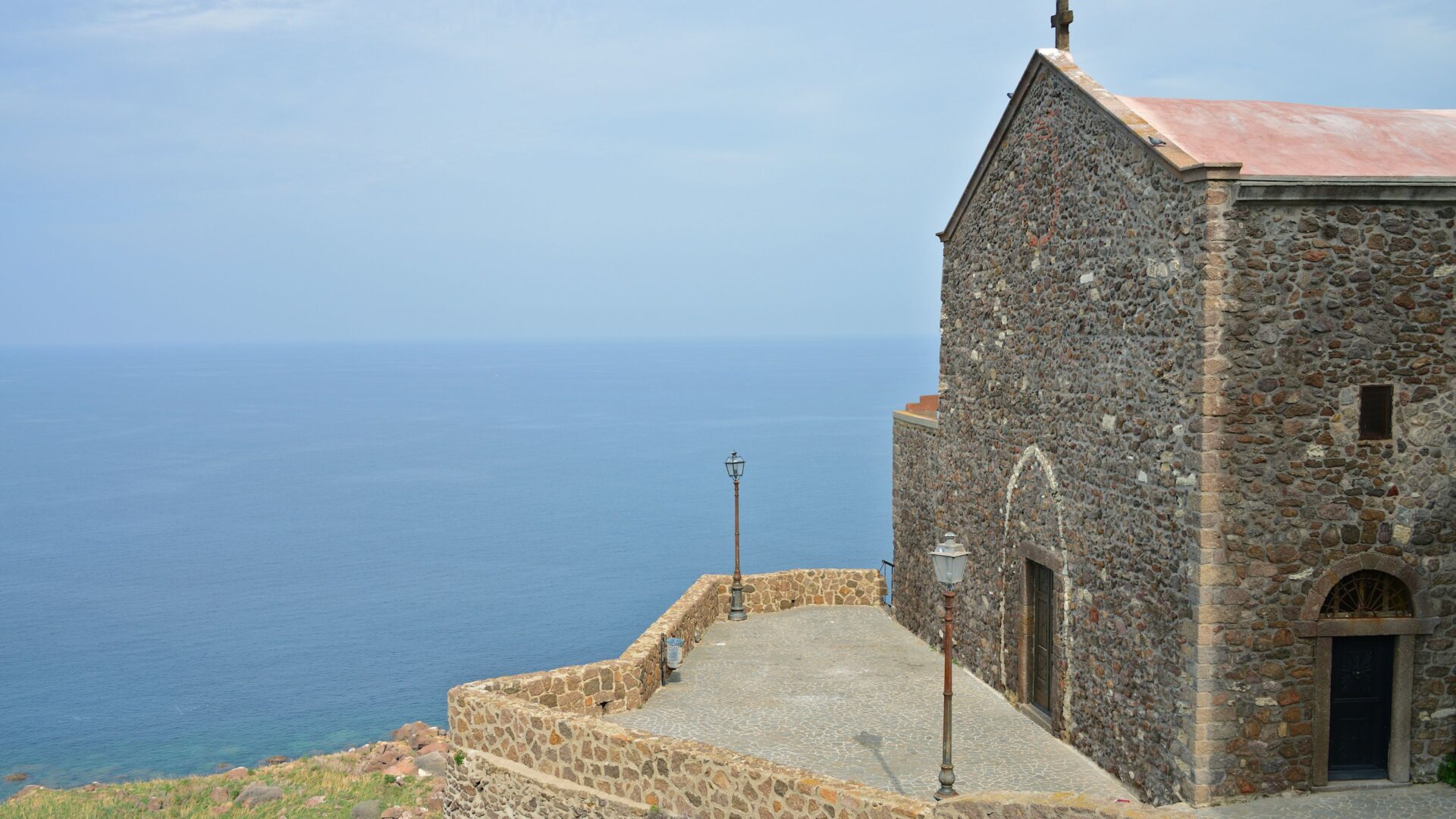 Cathedral of Sant'Antonio Abate perched on a cliff and overlooking the sea in Castelsardo, Sardinia, Italy