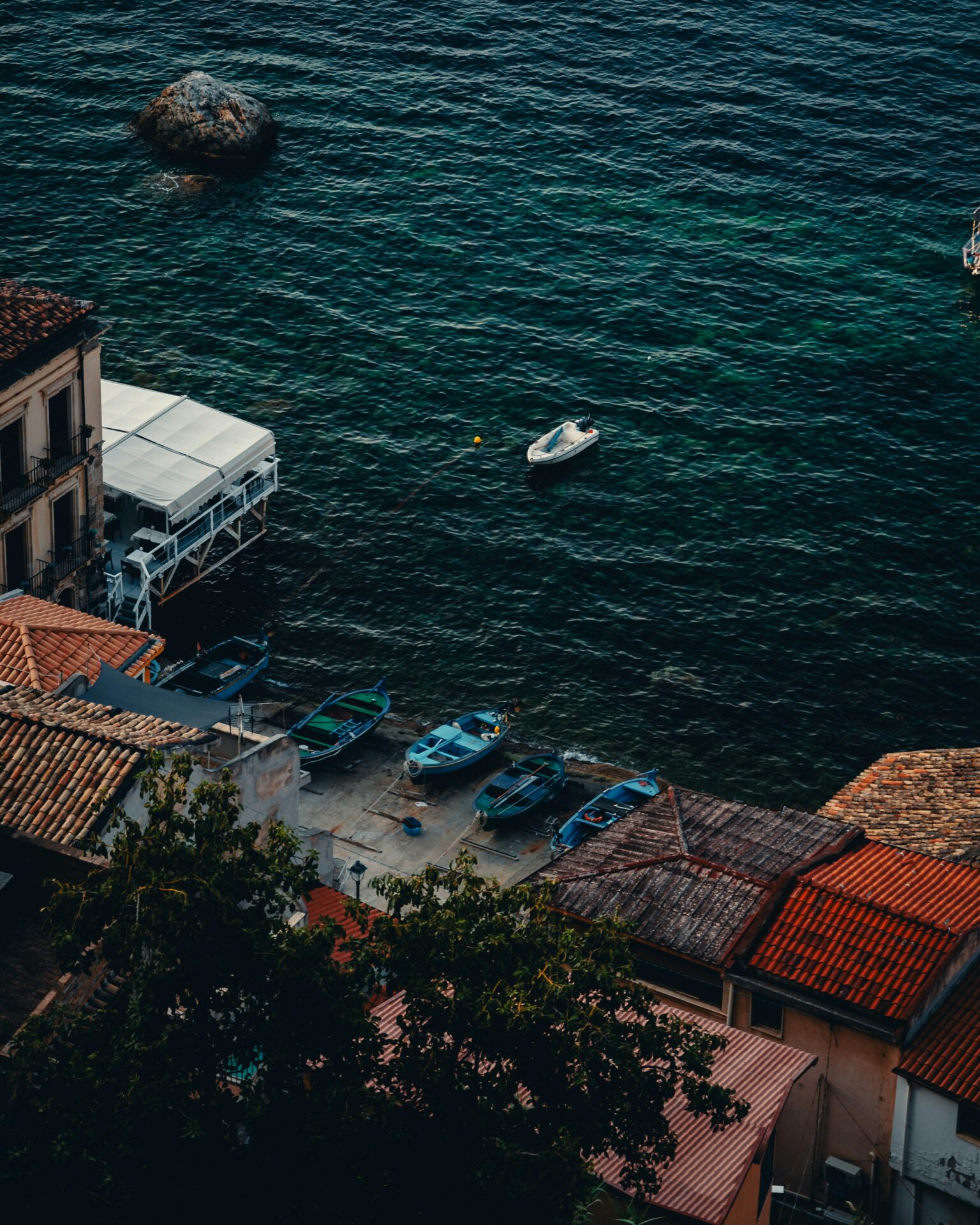 Twilight view of Chianalea di Scilla, where traditional homes line the rocky coastline
