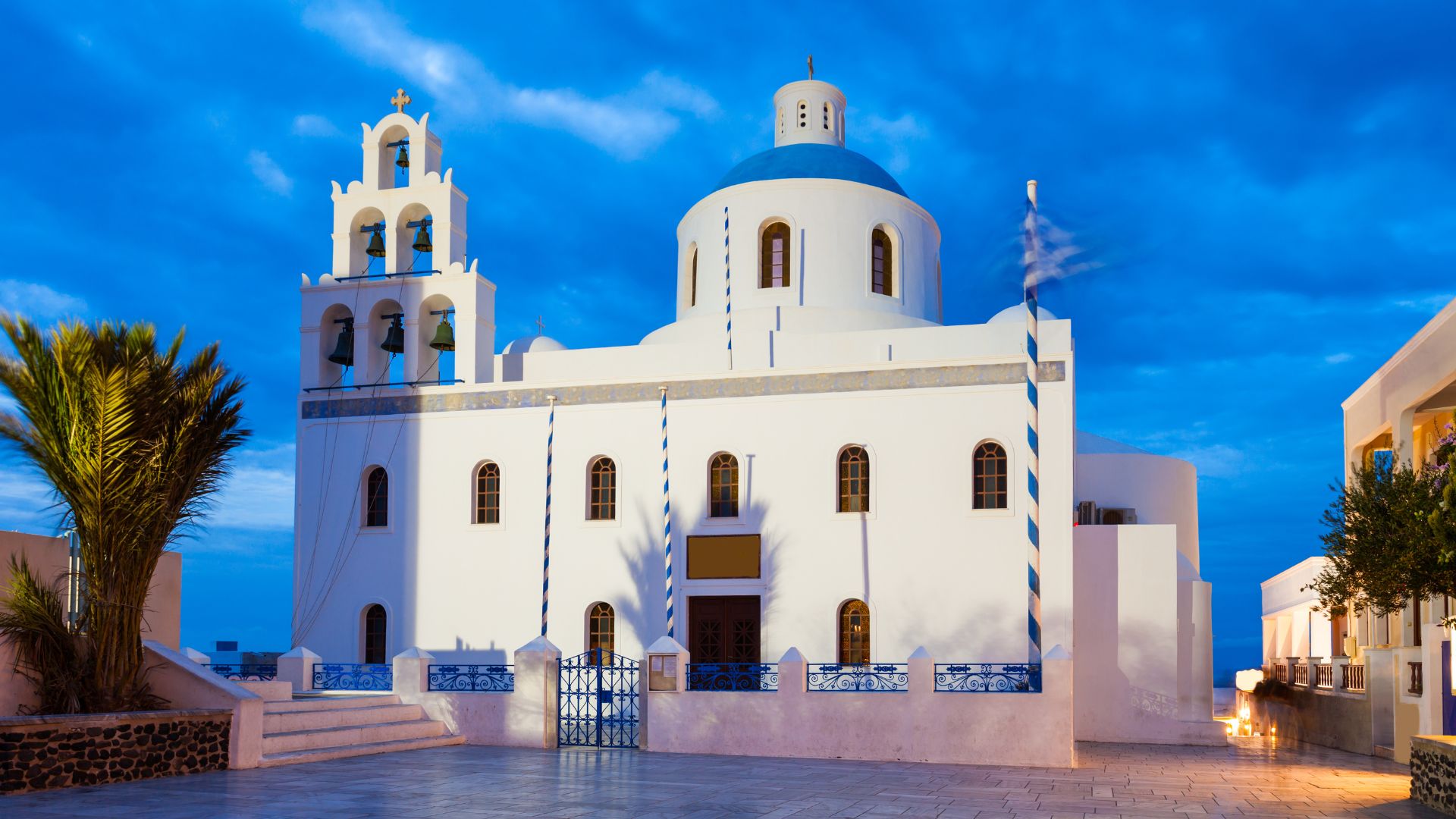 Ekklisia Panagia Platsani, a white church with a blue dome in Oia, Santorini.