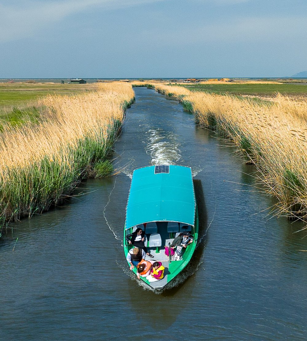 A boat drifting peacefully on the tranquil waters of Evros Delta