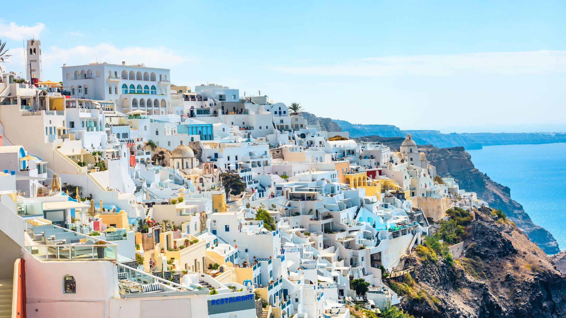 White buildings on a cliff overlooking the sea in Santorini, Greece.