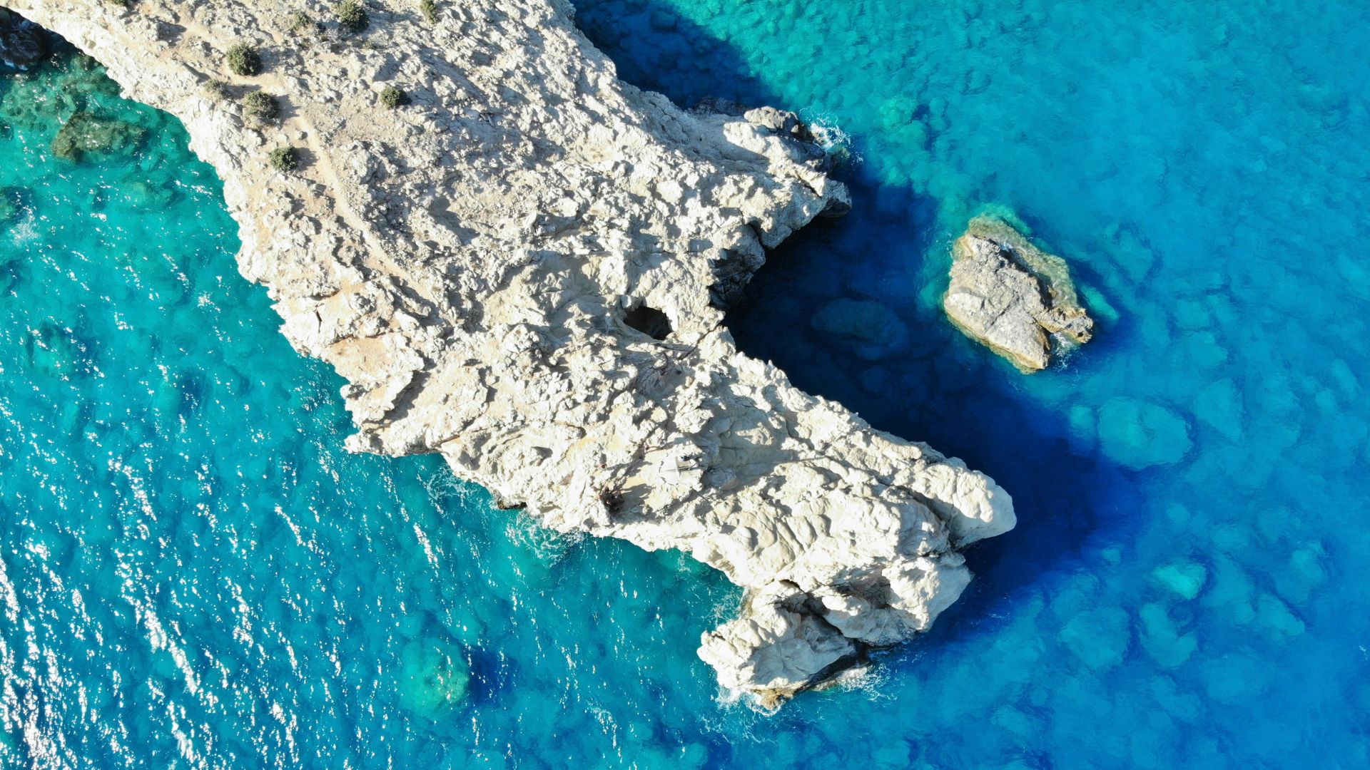 Aerial view of the rocky coast and turquoise waters of Gavdos, Greece.