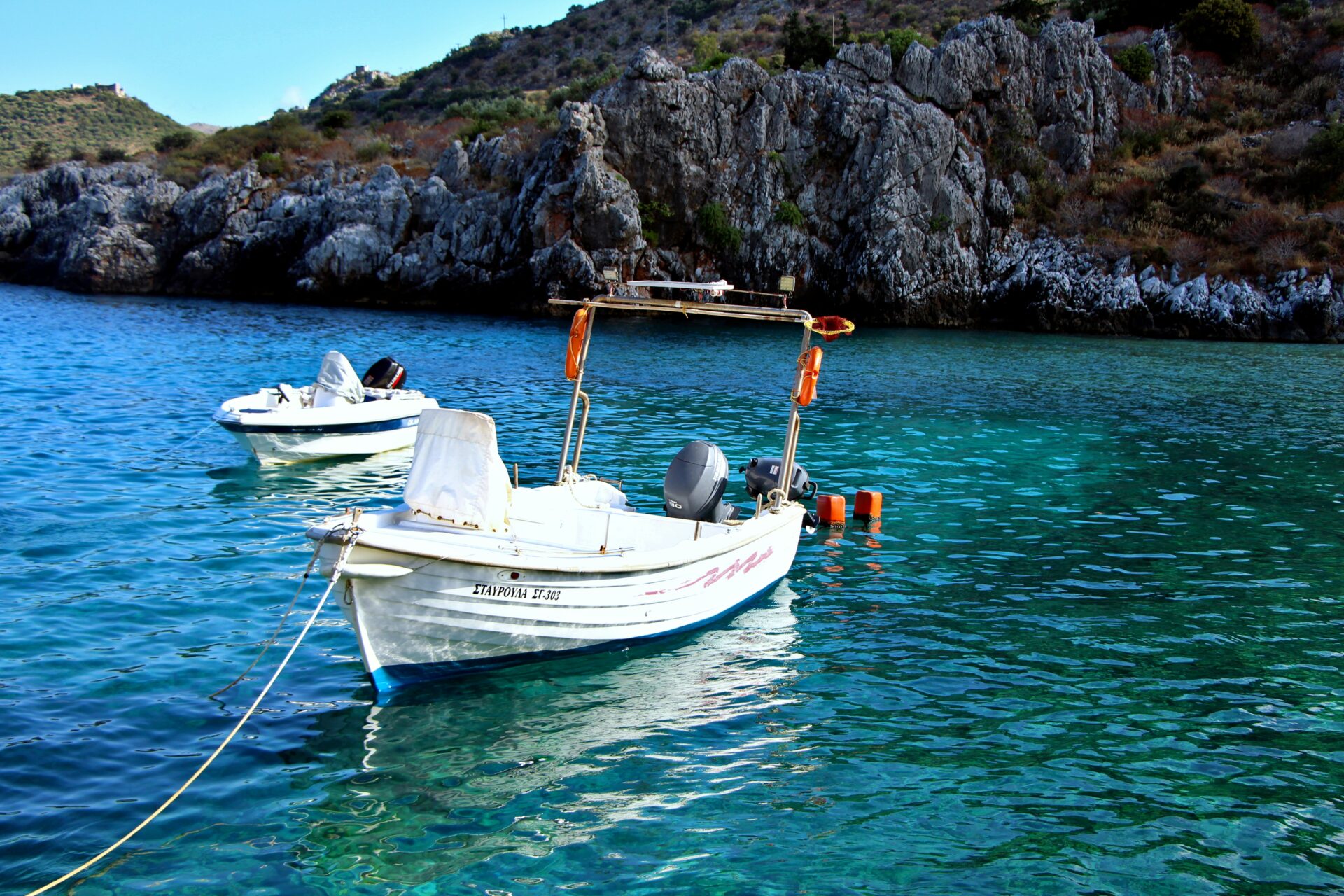 Rugged cliffs towering over the clear waters of Gerolimenas