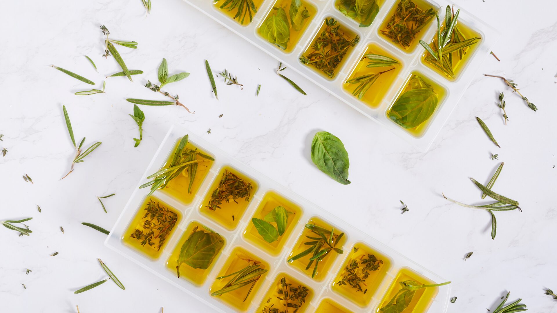 Herb Leaves and Olive Oil in Ice Maker