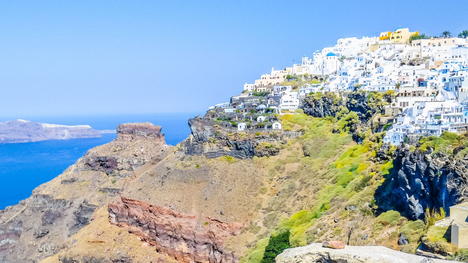Santorini caldera with white buildings on cliffs overlooking the sea.