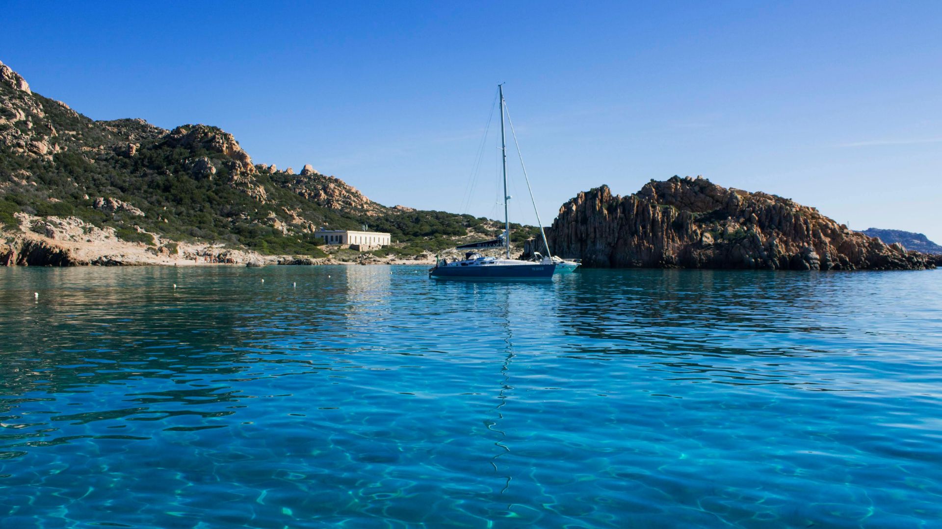 Sailboat in the clear waters of the Maddalena Archipelago.
