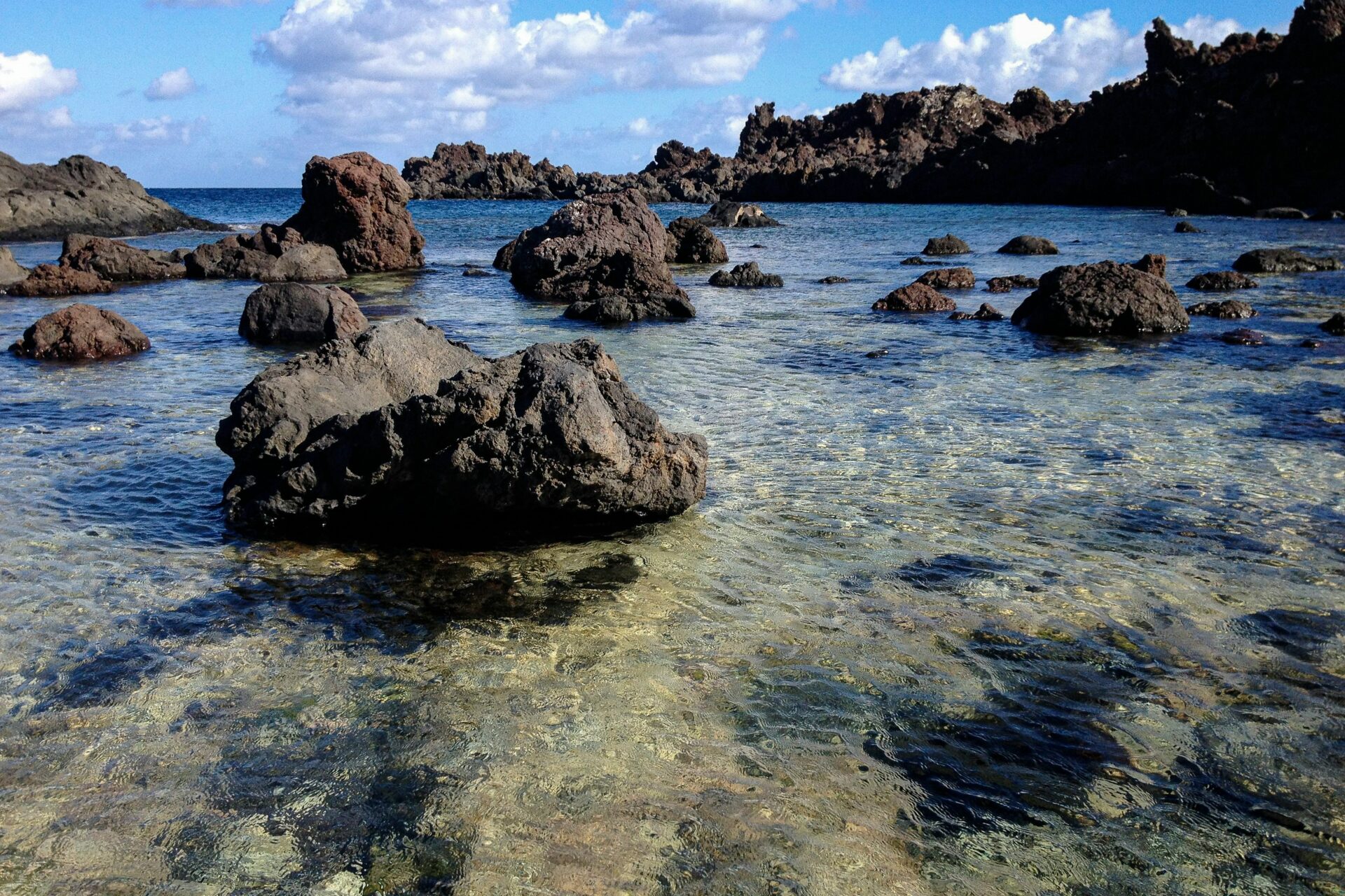 Dramatic black volcanic rock formations on the island of Linosa in the Pelagie Islands