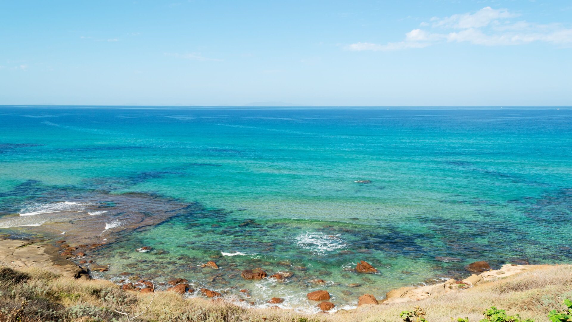 Lu Bagnu beach in Sardinia, Italy characterized by clear blue waters.