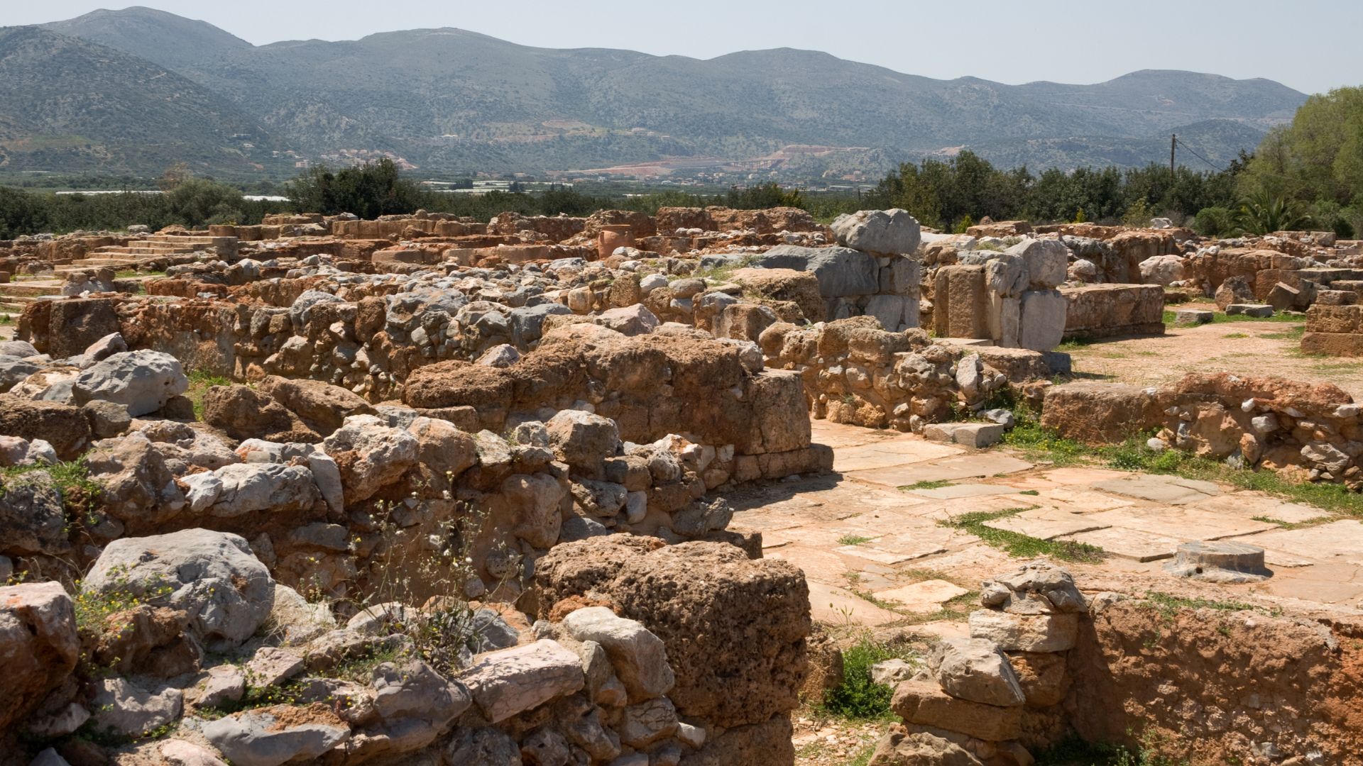 Ruins of the Palace of Malia, an ancient Minoan site with stone structures.