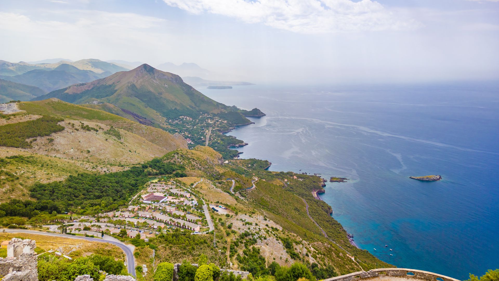 The image shows the coastline of Maratea, Italy, specifically an area near the Cristo Redentore statue, located on Monte San Biagio.