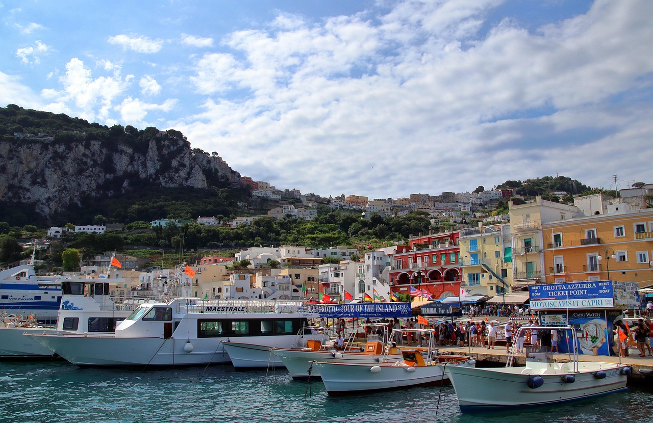 Colorful buildings and boats docked at Marina Grande, the bustling main port of Capri, Italy.
