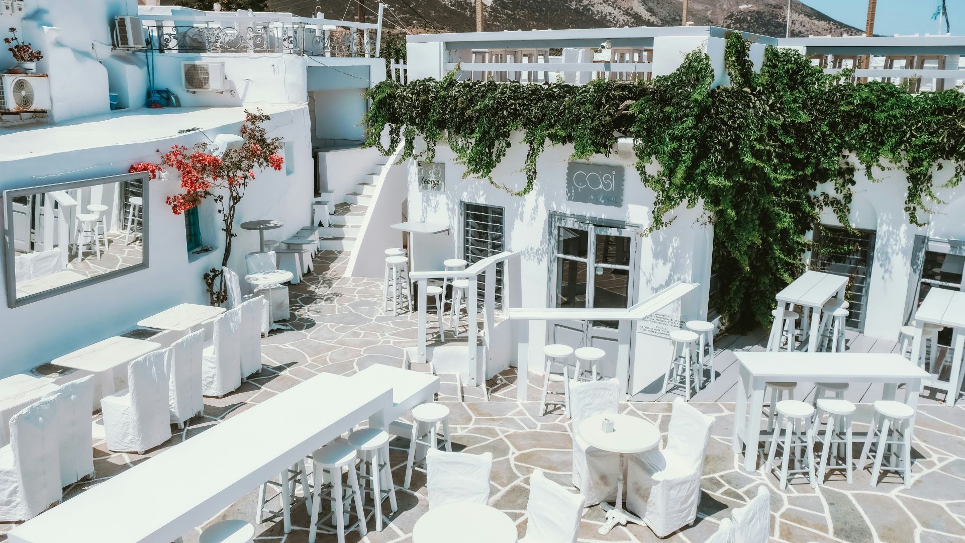Apollonion restaurant on Milos Island. The restaurant features a white exterior with outdoor seating and is known for its Cycladic architecture.