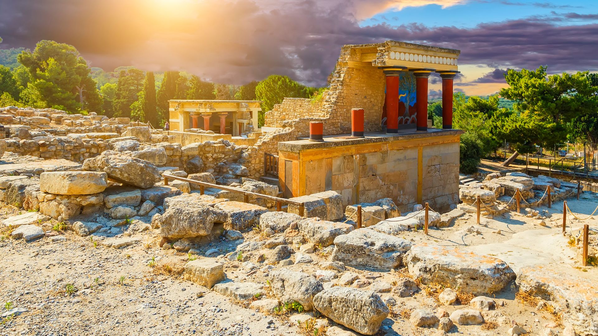Ruins of the ancient Minoan palace of Knossos in Crete, featuring stone structures and columns.