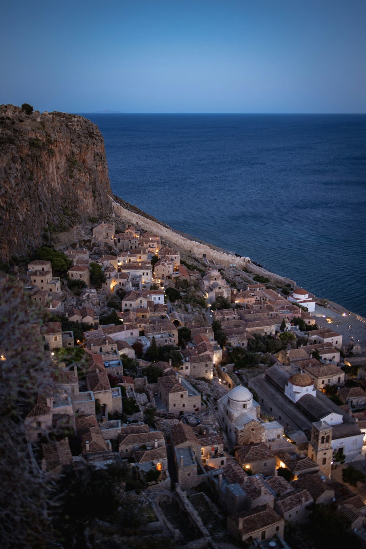 Monemvasia at night: The medieval town’s stone streets and ancient fortress glow under the soft light