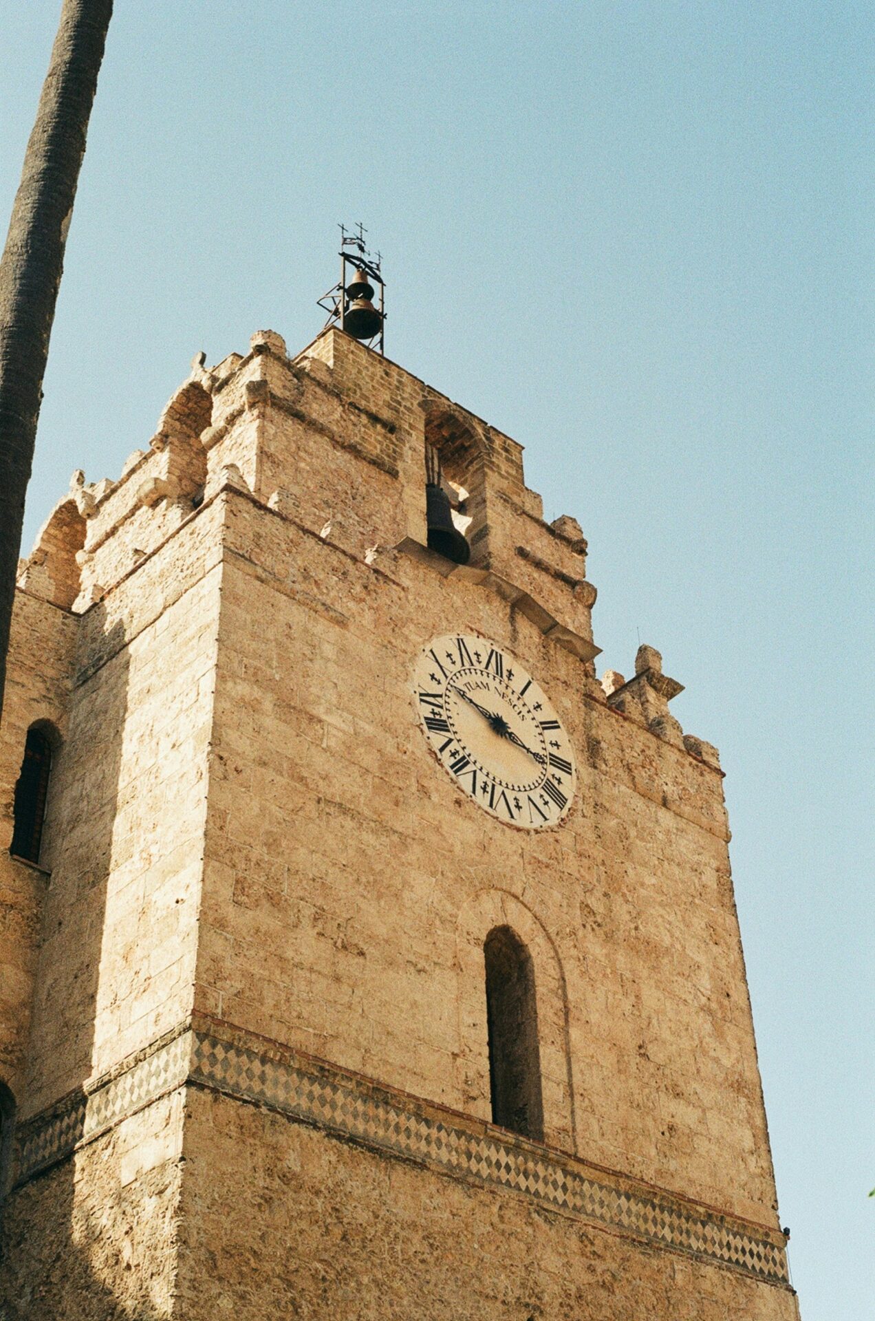 Close-up of the Monreale Cathedral bell suspended in a stone tower