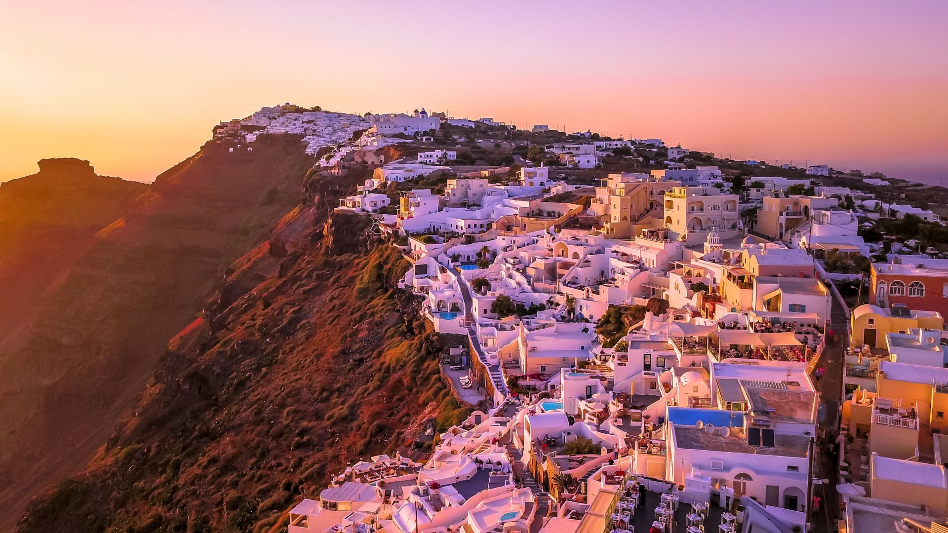 Sunset view of white buildings in Oia, Santorini