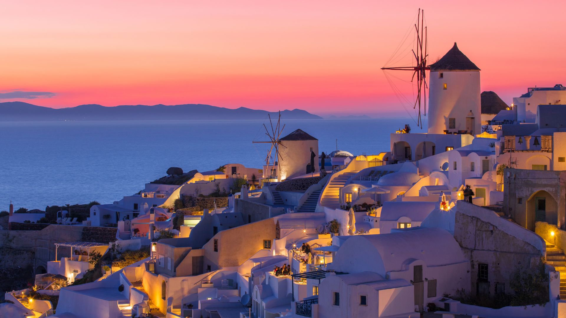 Sunset view of white buildings in Oia, Santorini