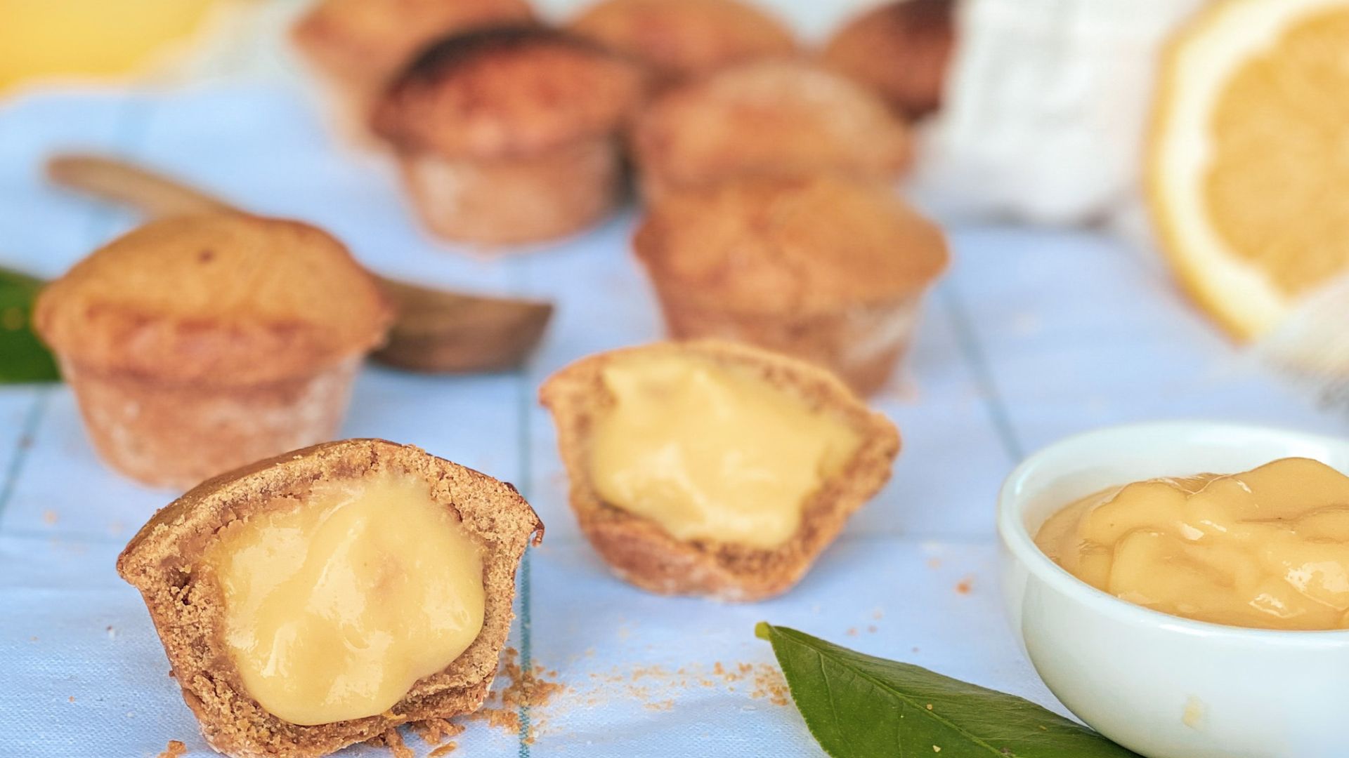 Image shows oblong, golden treats consist of a shortcrust pastry shell filled with a warm, lemon-flavored custard- Pasticciotti (sweet pastries).