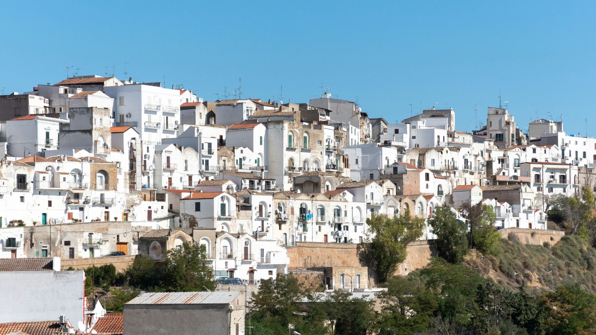 Image shows white houses at Pisticci, Italy.