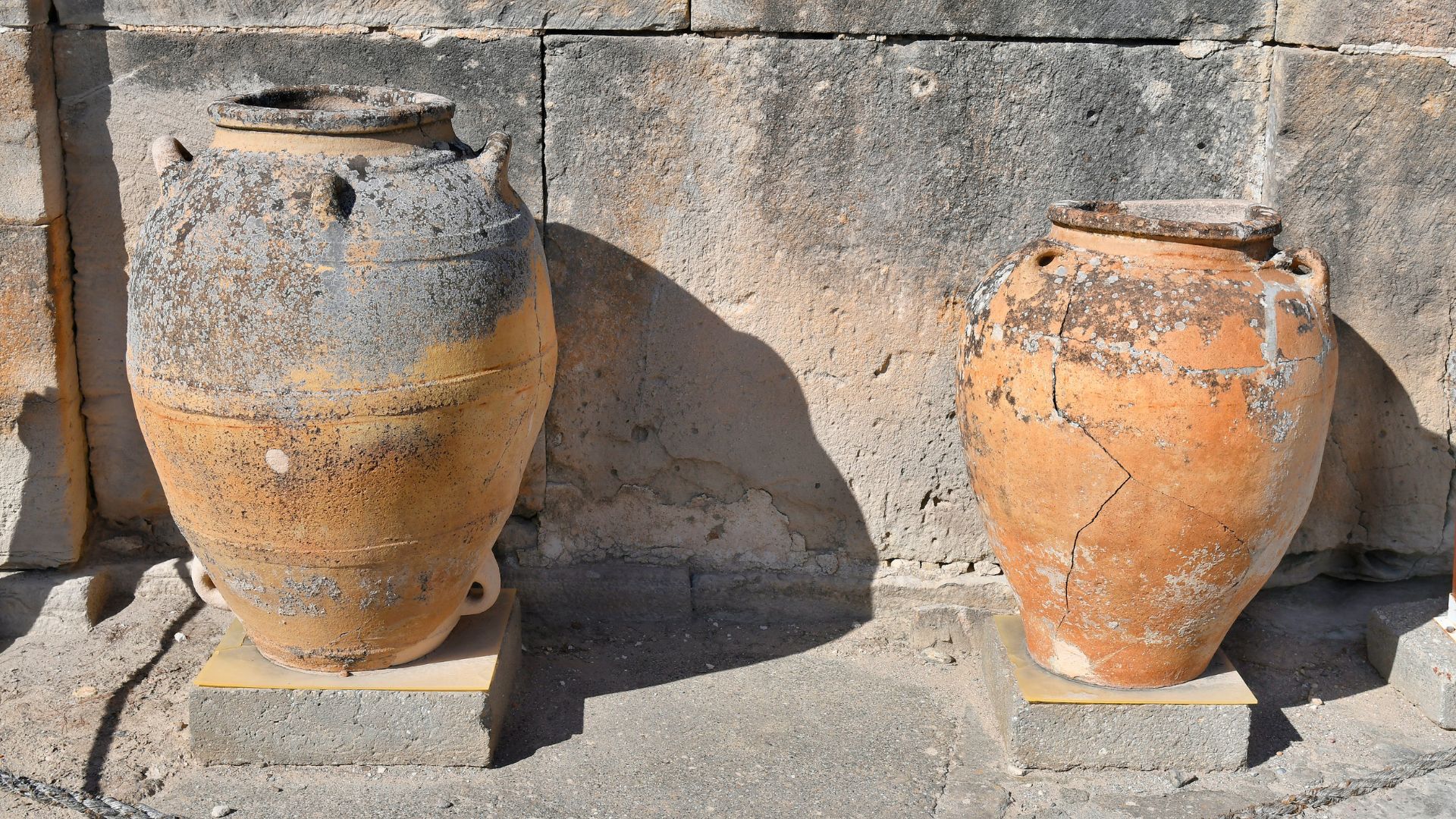 Two large, ancient Pithoi storage jars on display, possibly from Knossos, Crete.