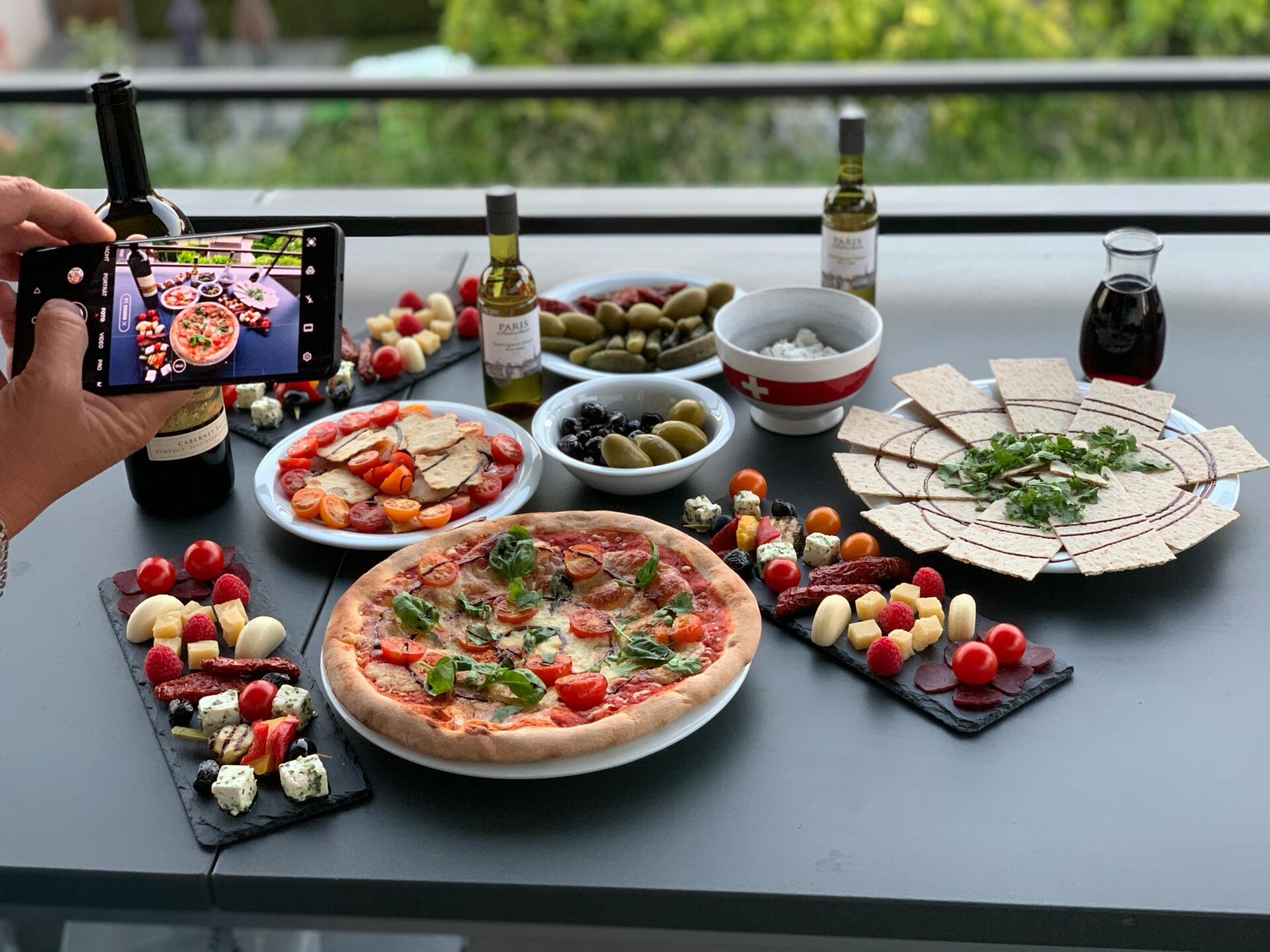Pizza, Italian appetizers, wine, olives, and olive oil