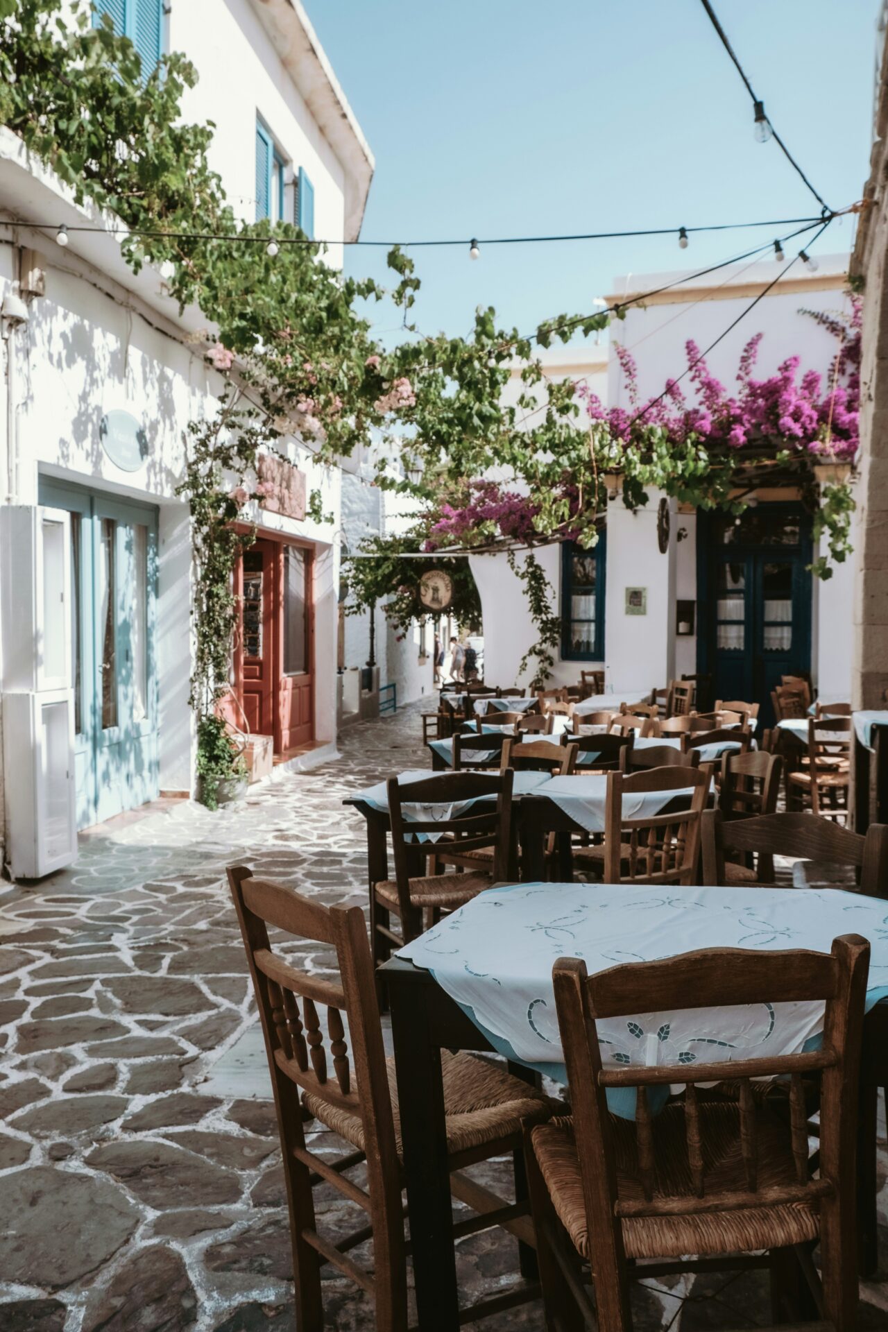 Plaka cobblestone street with tables and chairs