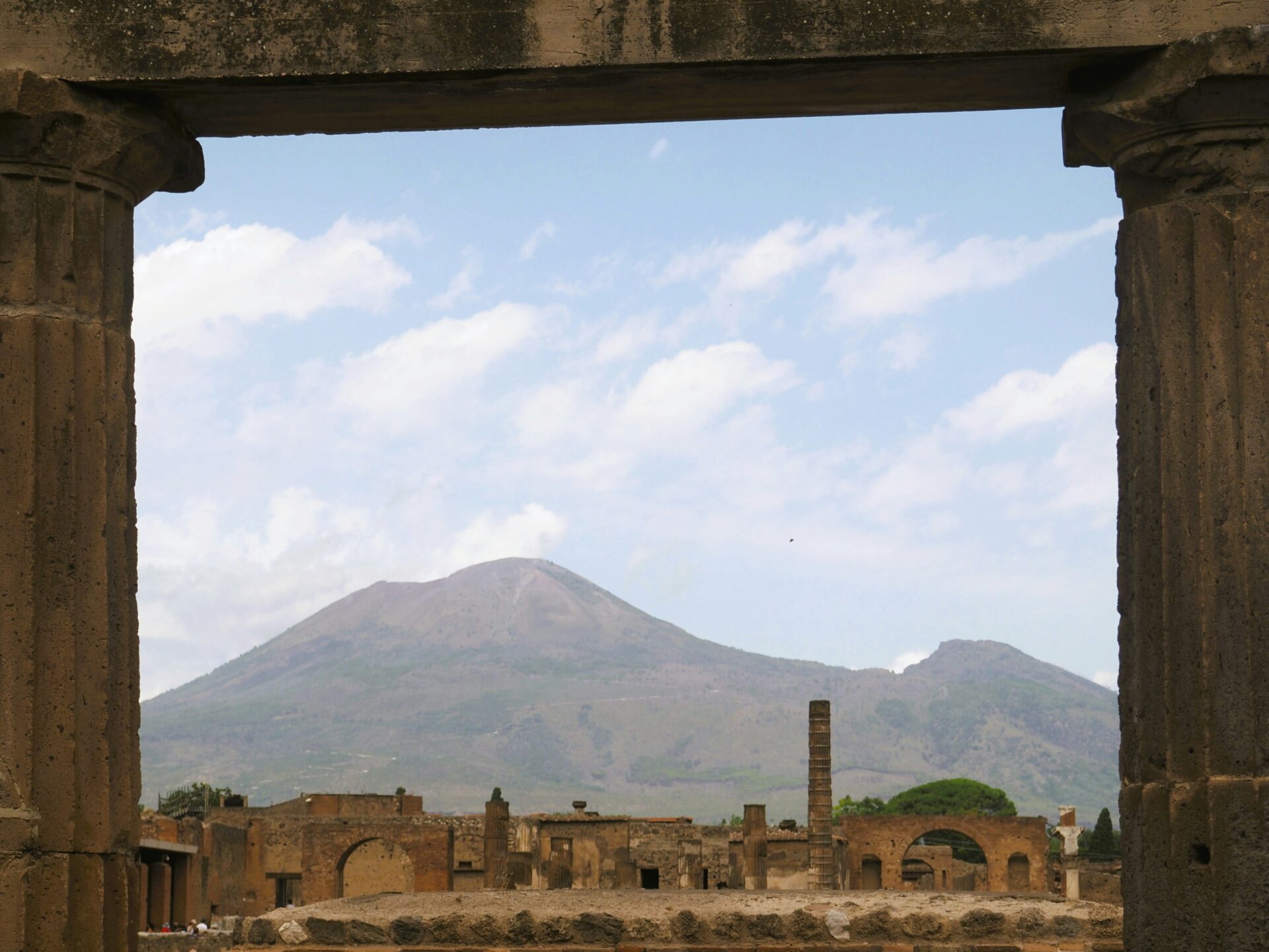 View of Mount Vesuvius framed by ancient ruins in Pompeii, Metropolitan City of Naples, Italy.